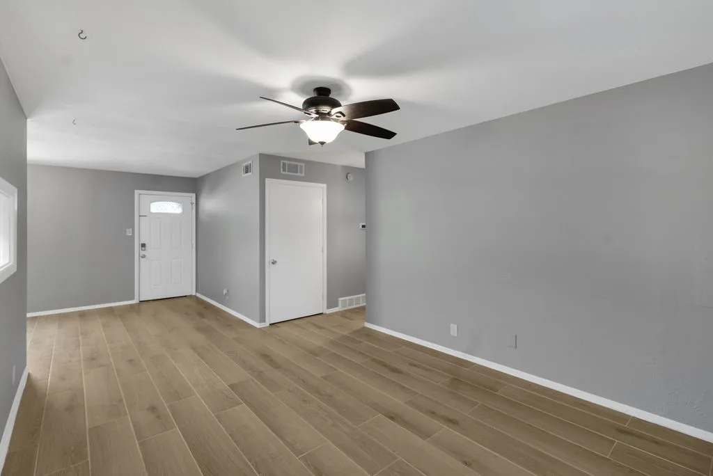 Living room towards front door.  Coat closet in hallway towards bedrooms and baths.