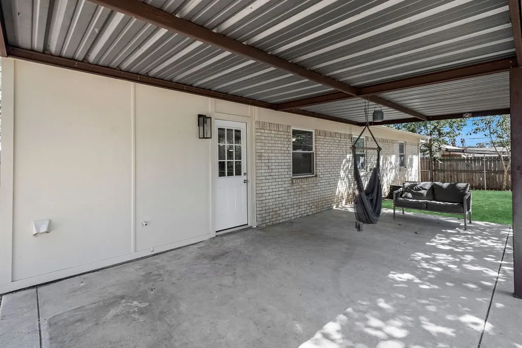 Large covered patio with door into laundry room.