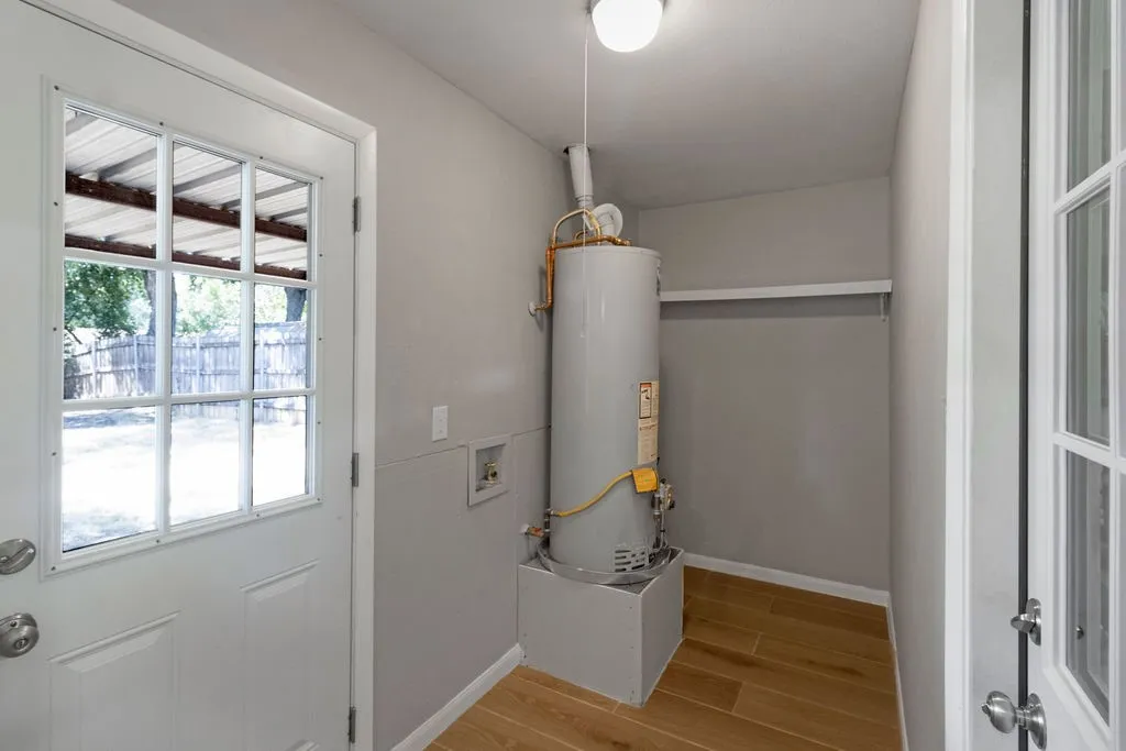 Huge laundry room! Full size washer and dryer area with extra storage!  Door on left to covered patio, door on right to garage.