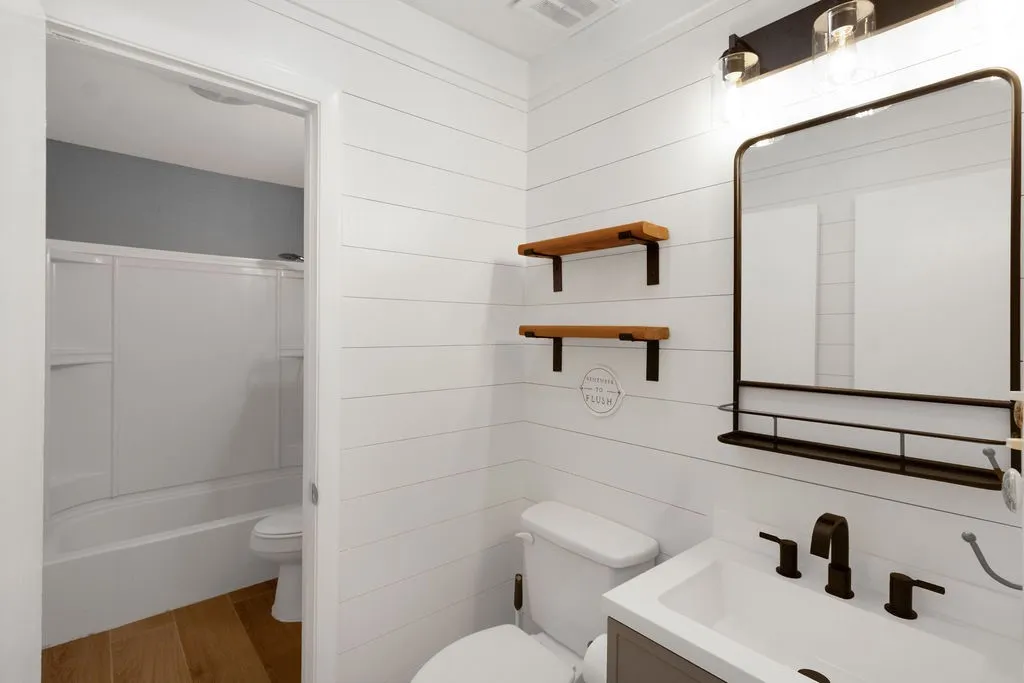 Hall half bath with door into full bath which is also accessible from primary bedroom. New vanity!