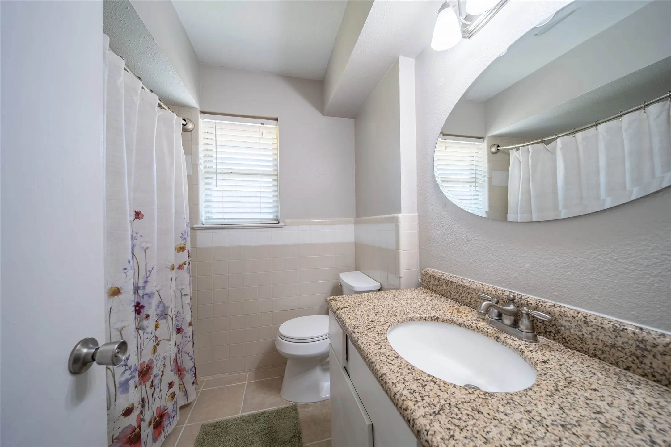 The full bathroom is located off the hallway and around the corner from the dining room.