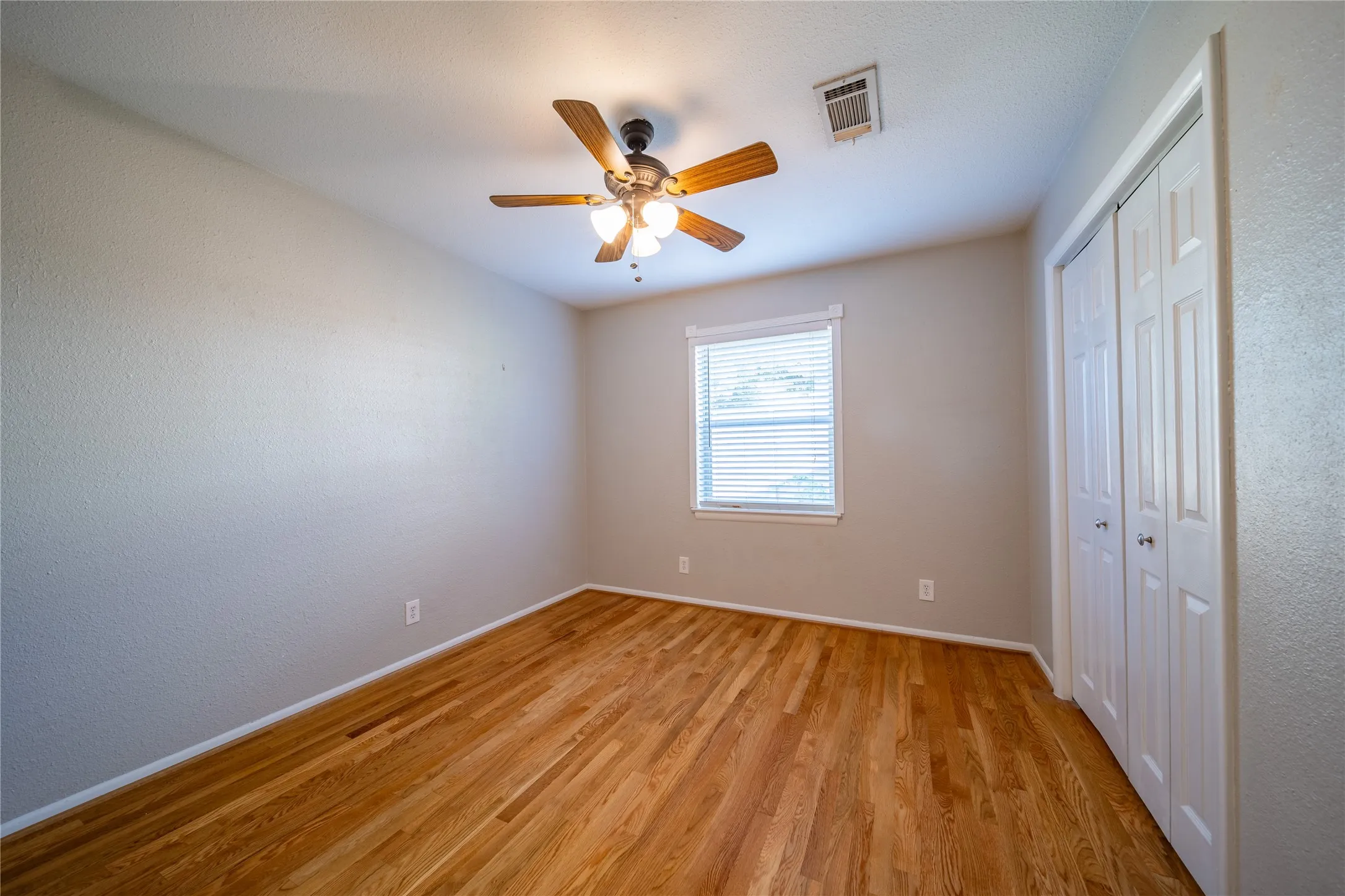 The second bedroom with views to the side yard is located between the primary and the third bedroom.