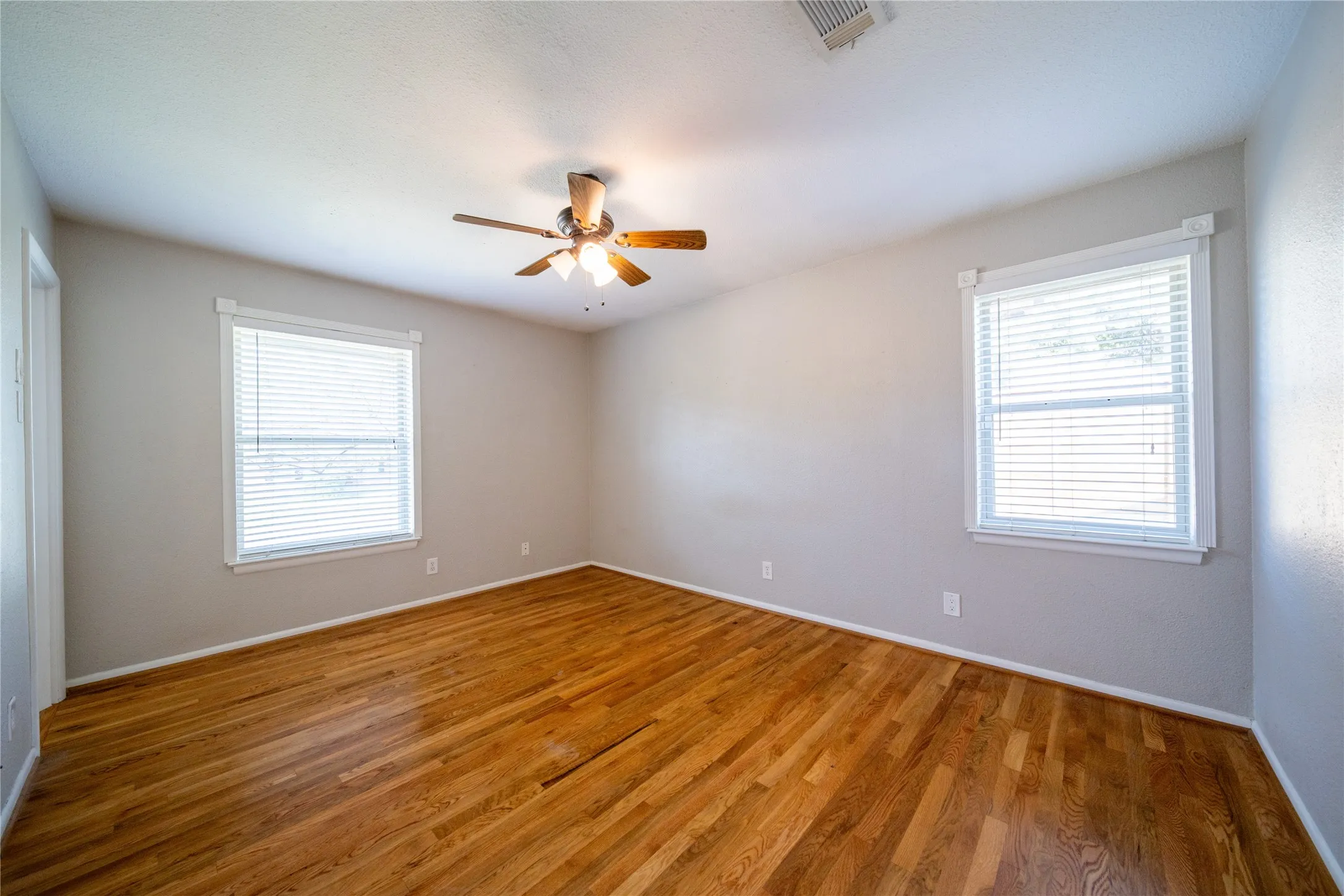 The primary bedroom is located at the front of the home and has views to the front and side yard. The door in the extreme left of the photo is the ensuite bathroom.