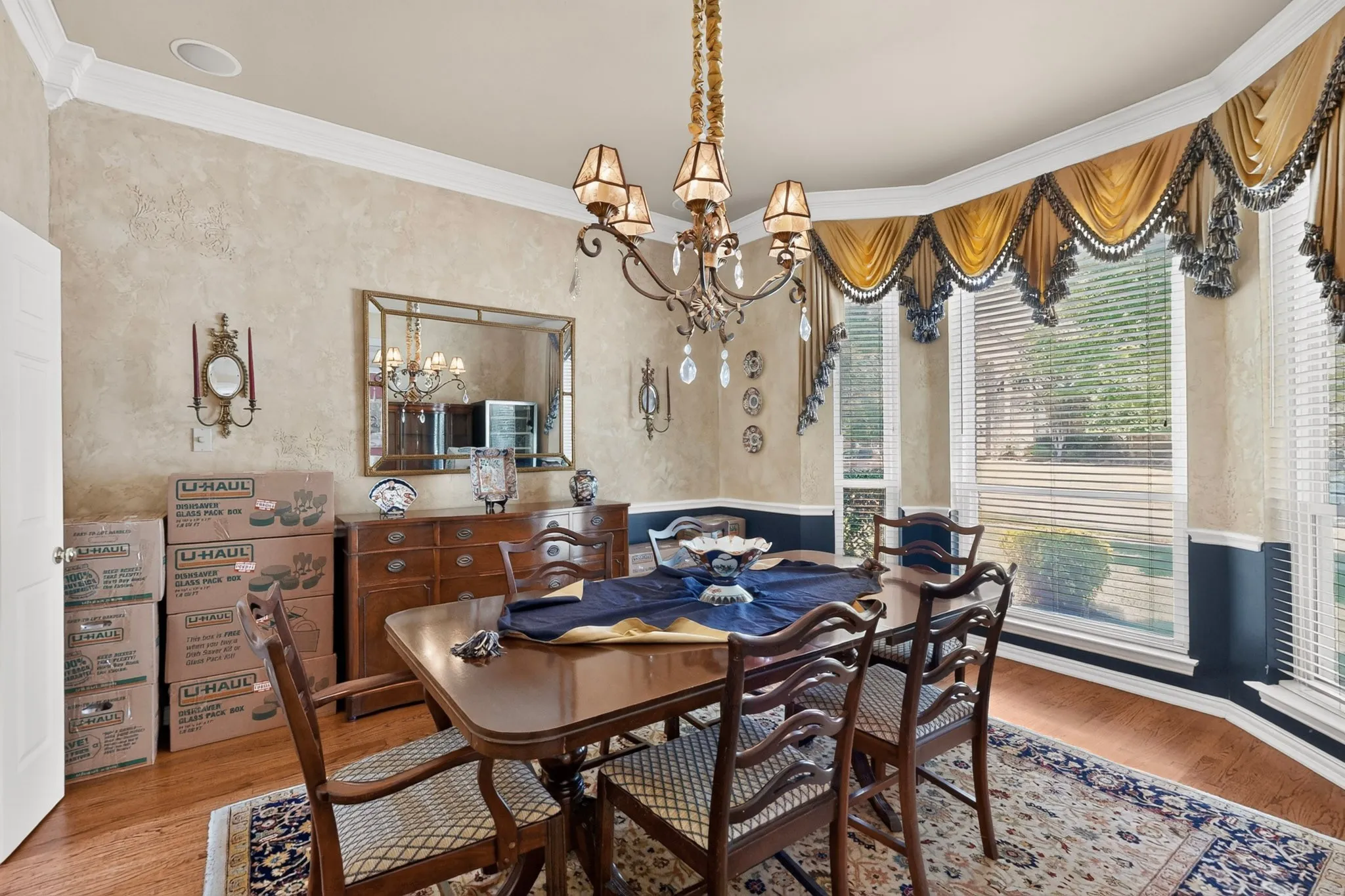 Hardwood flooring, crown molding, chandelier lighting, sconce wall lighting, bay window