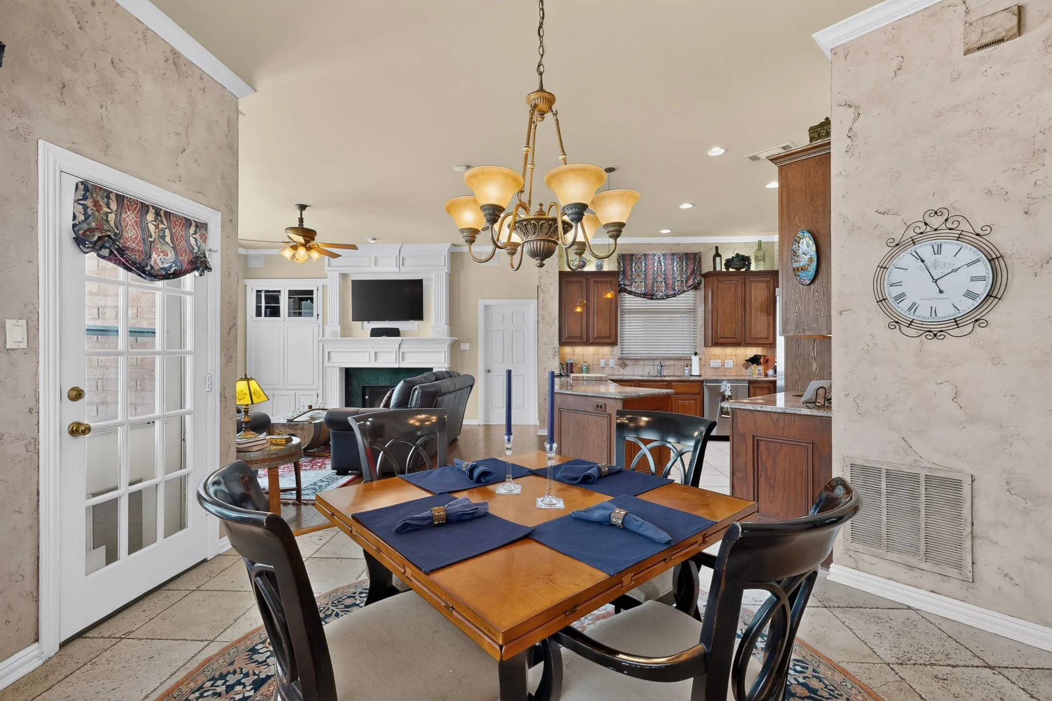 Open-concept dining area with tile flooring and a decorative chandelier