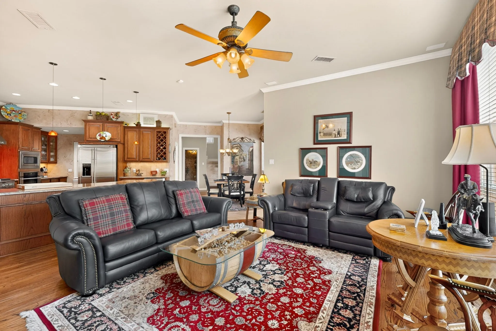 Wood-finish flooring with a ceiling fan overhead