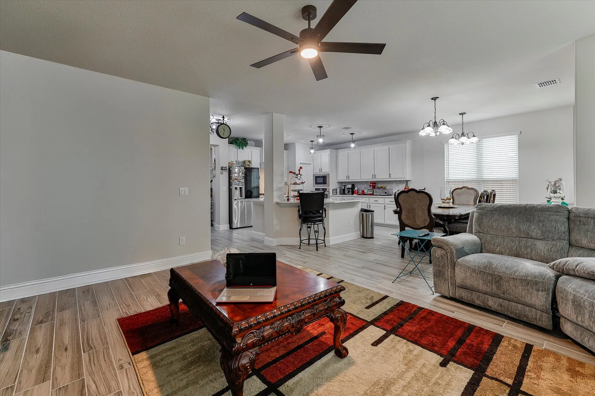 Wood-finish flooring throughout, with a ceiling fan with integrated lighting