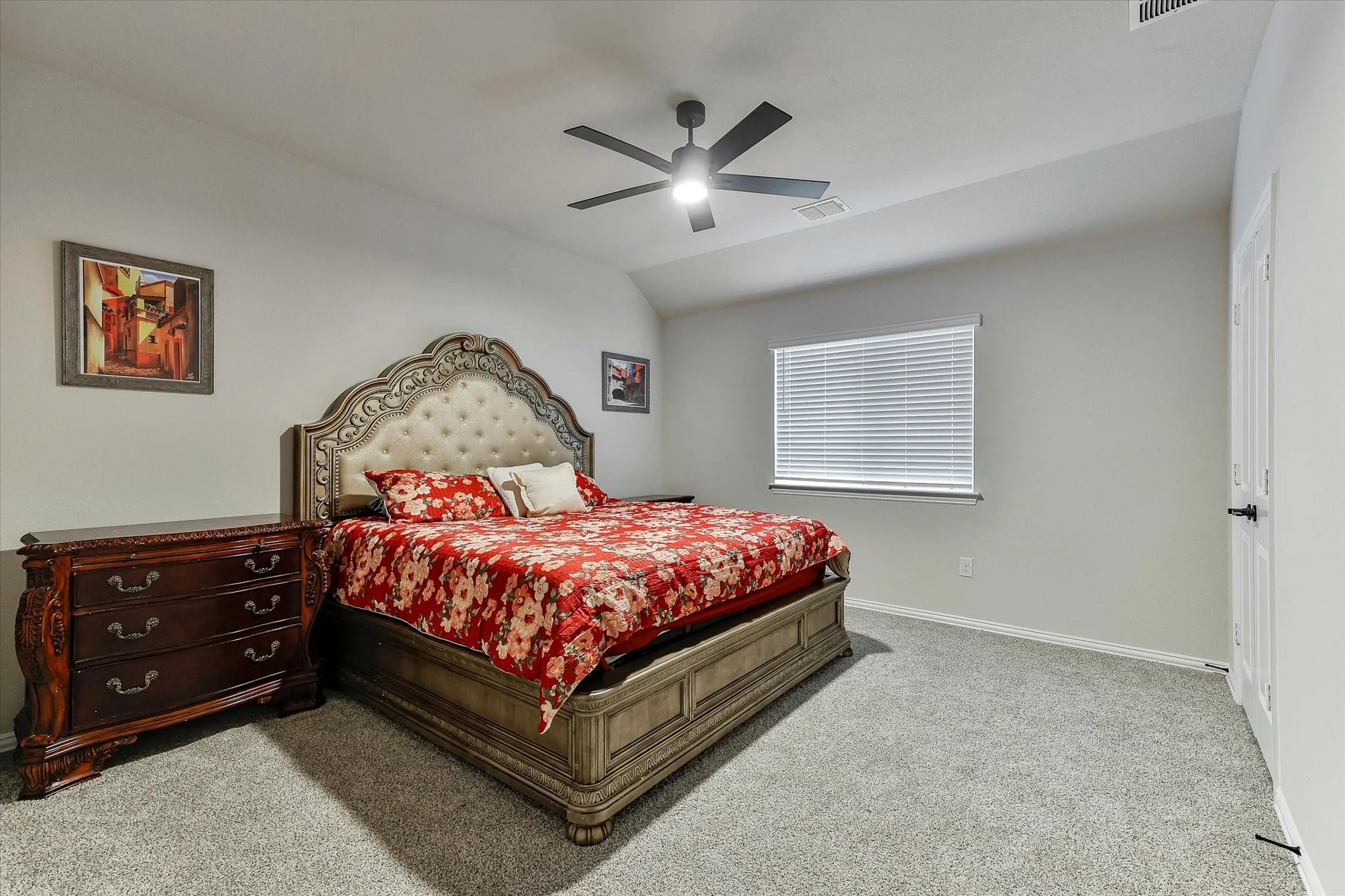 Plush carpet flooring, neutral painted walls, a window with blinds, and a ceiling fan with integrated lighting