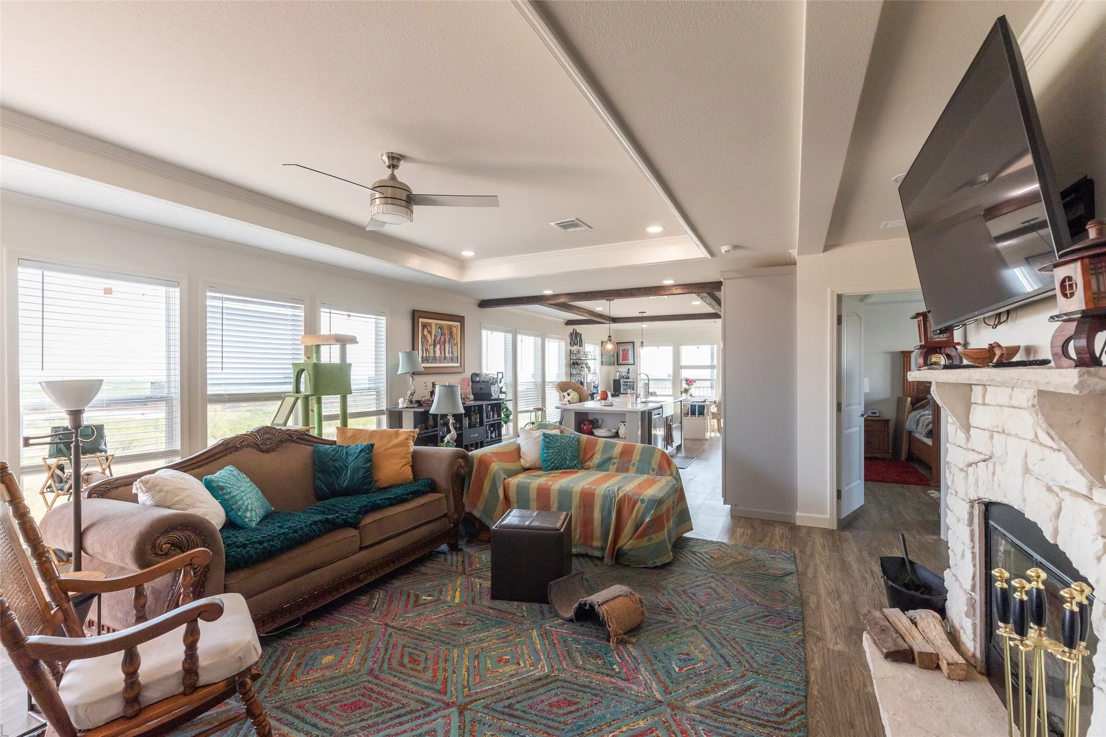 Natural lighting throughout with large windows. Living Area looking into Primary Bedroom, Kitchen, Dining Area, and turn the corner you get the Laundry Room