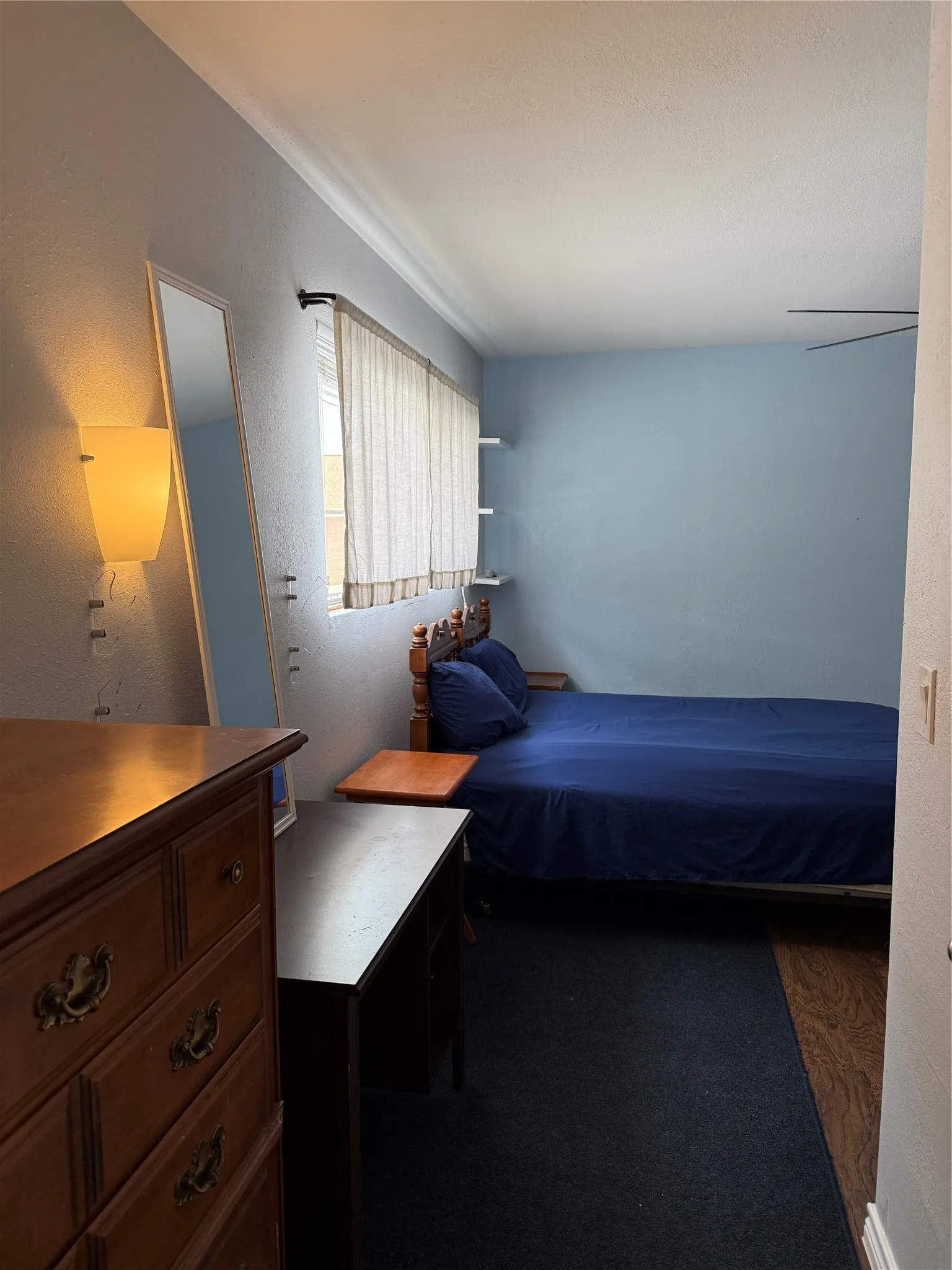Bedroom featuring a ceiling fan, crown molding, and a window with blinds