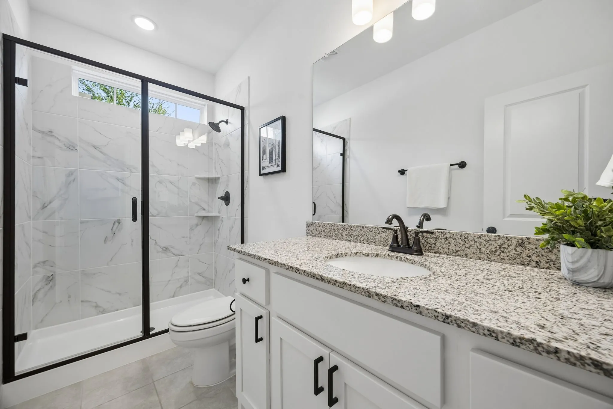 oversized walk in shower with large counter space vanity and storage