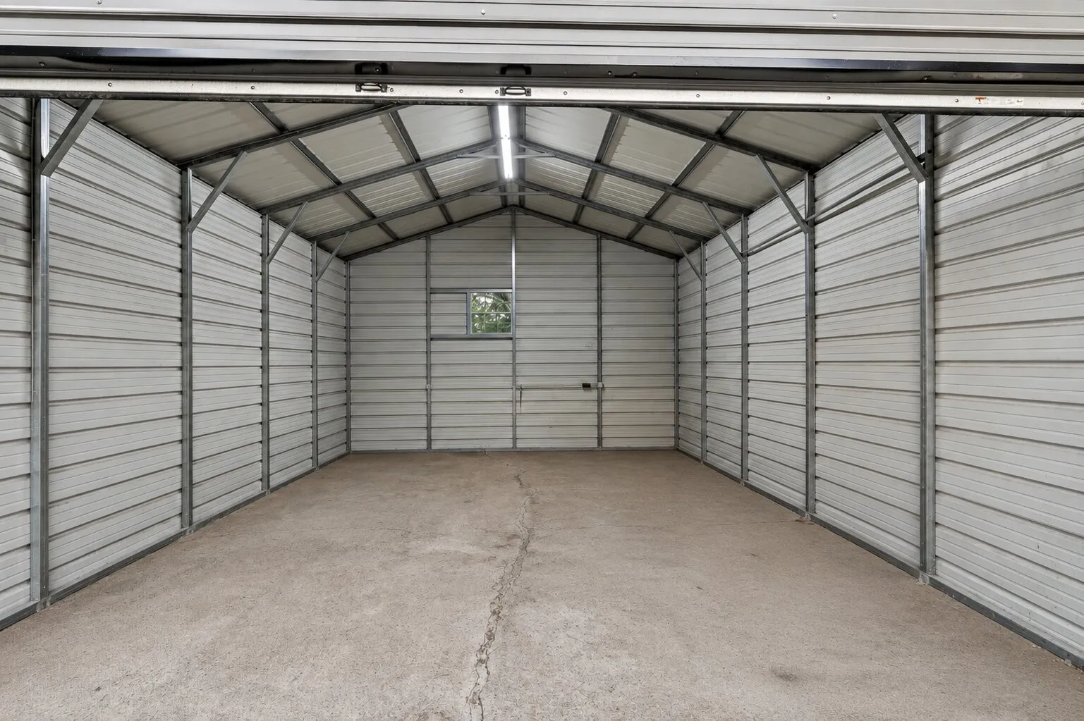 Metal frame structure with corrugated panel walls and a gabled roof