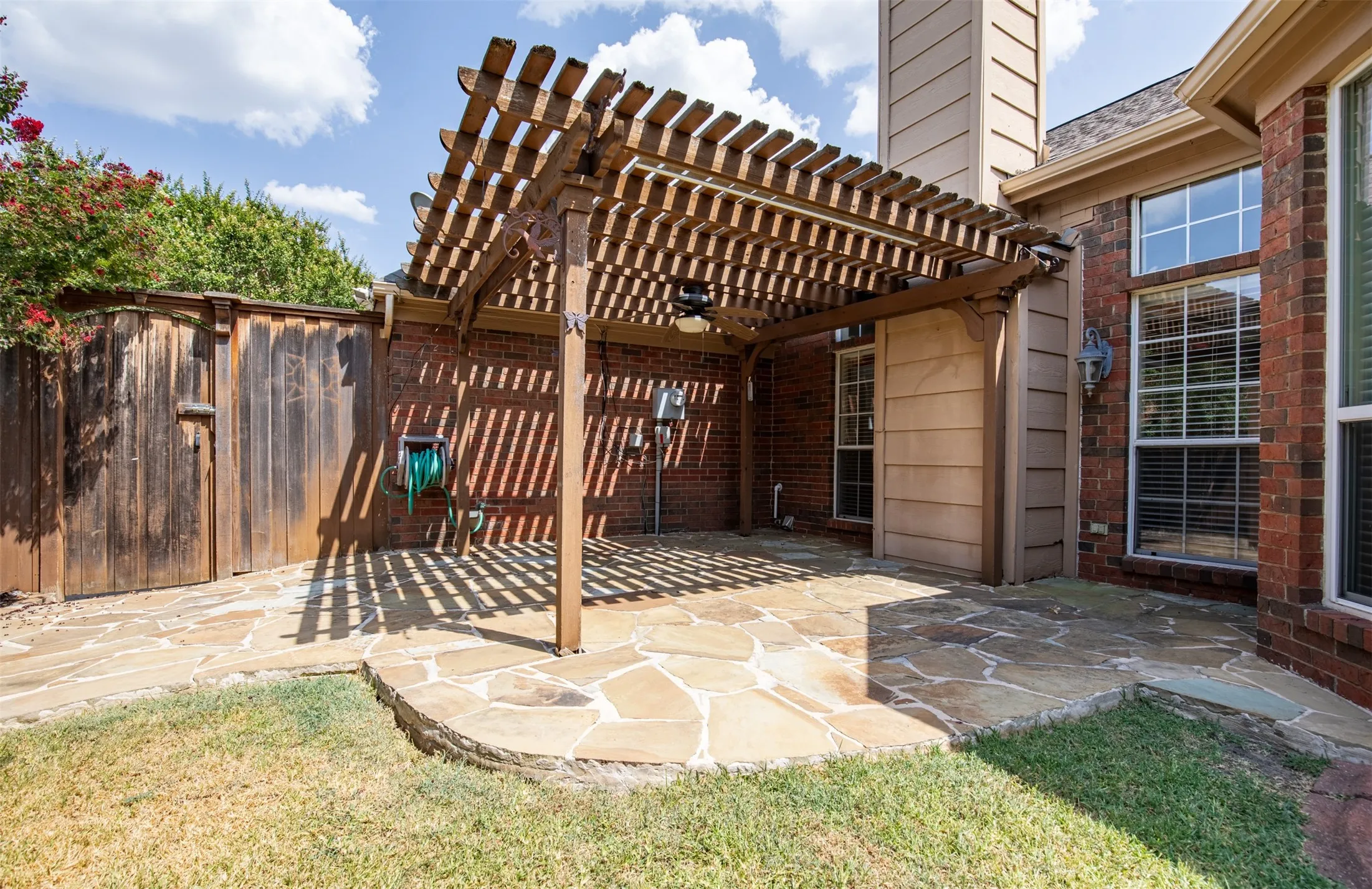 Covered pergola patio with flagstone.