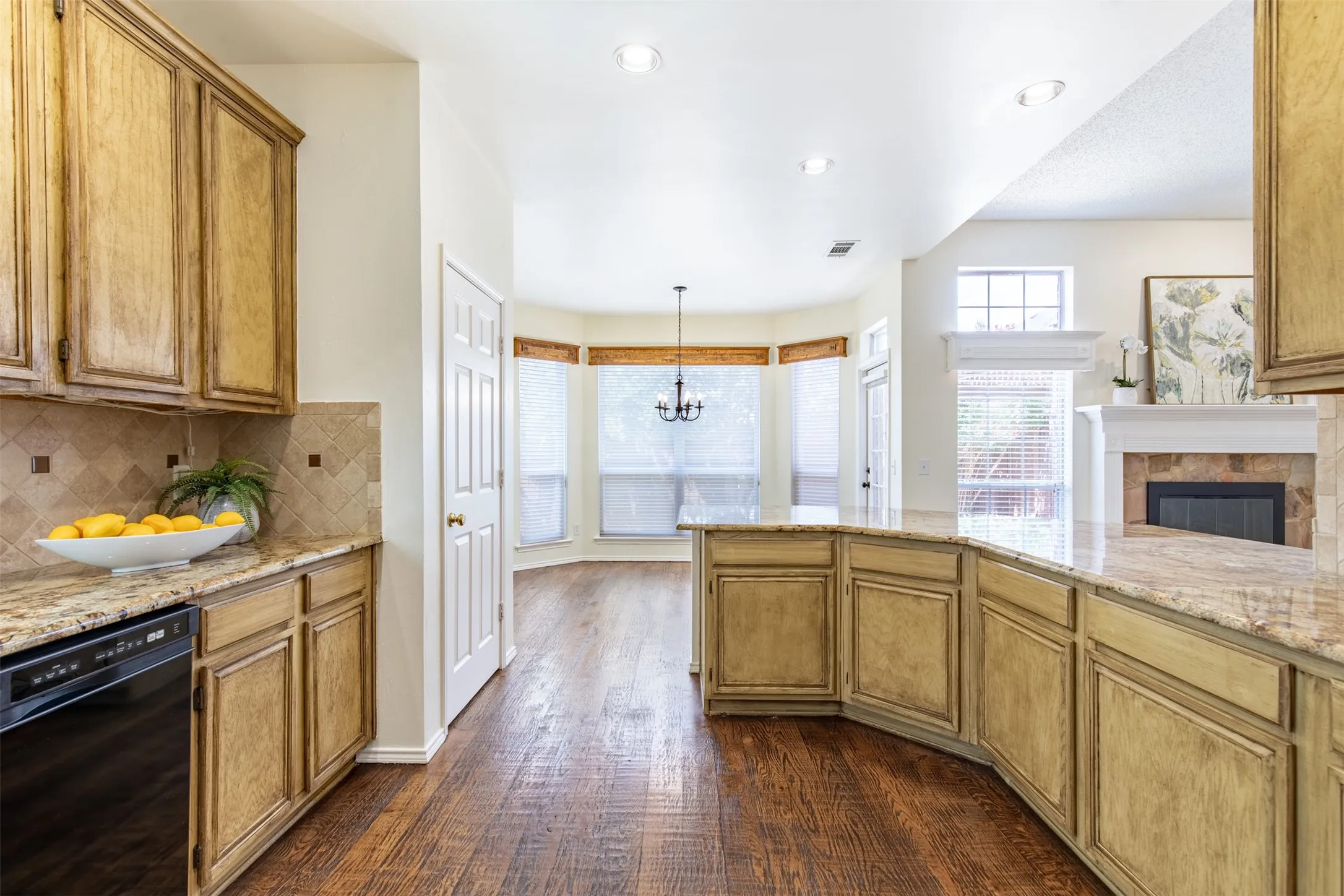 Kitchen features wrap around, eat-in breakfast bar.