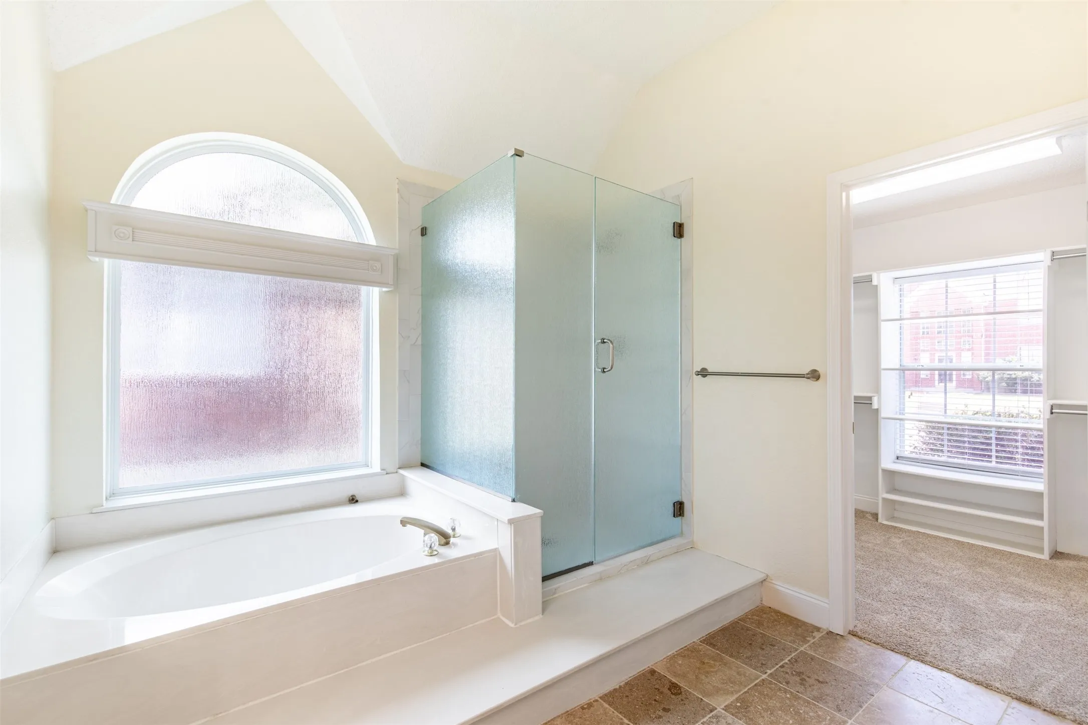 En-suite bath with soaking tub and separate shower.