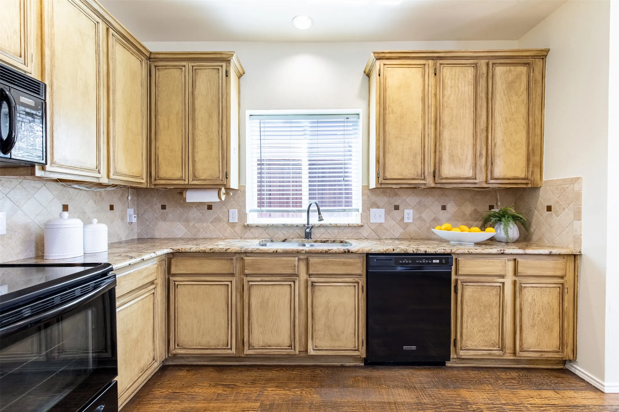 Kitchen features granite countertops and natural light.