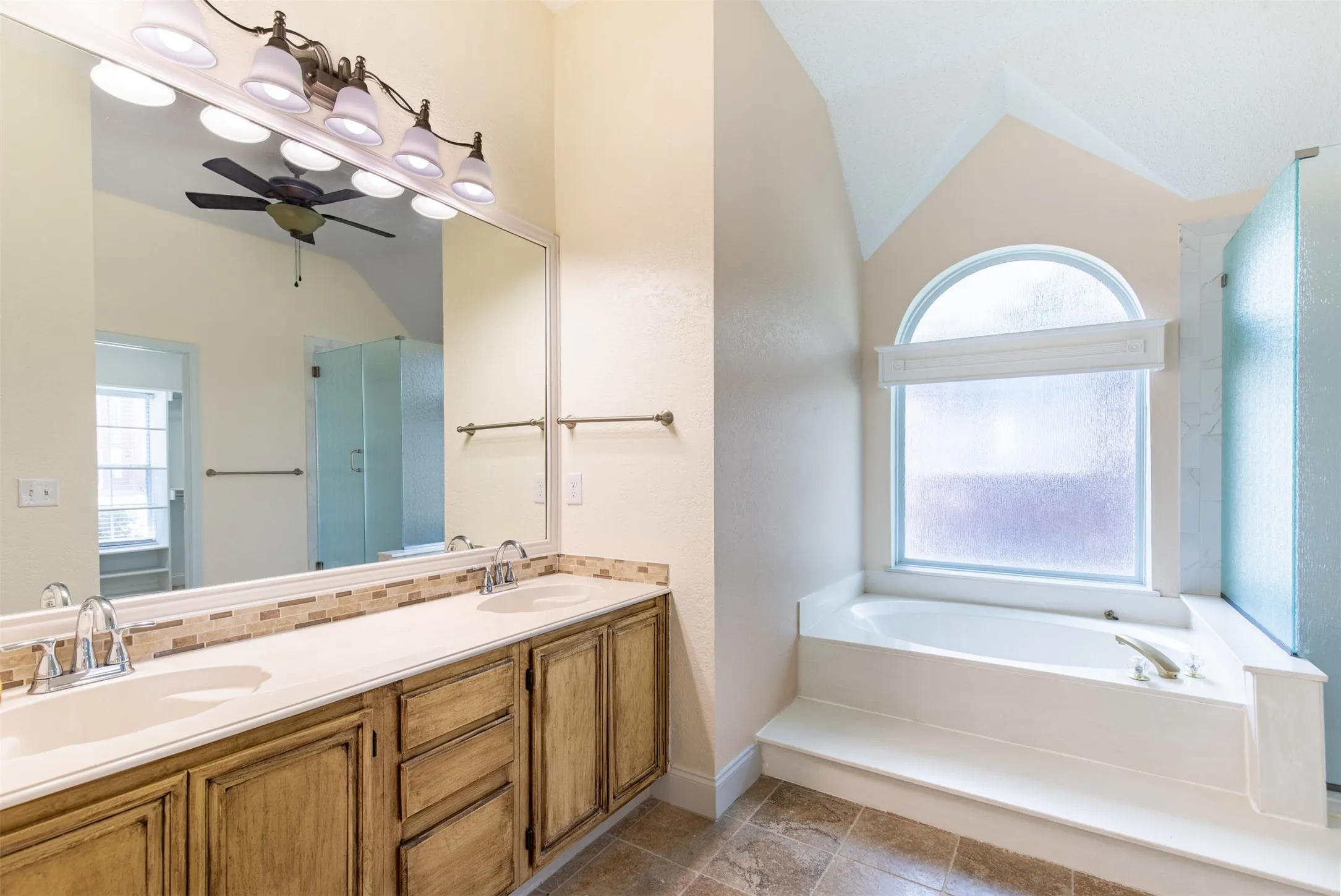 En-suite bath with dual sinks and soaking tub.