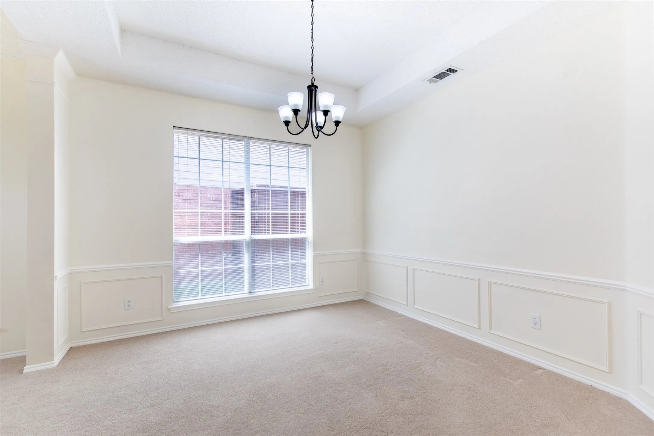 Formal dining room with natural light.