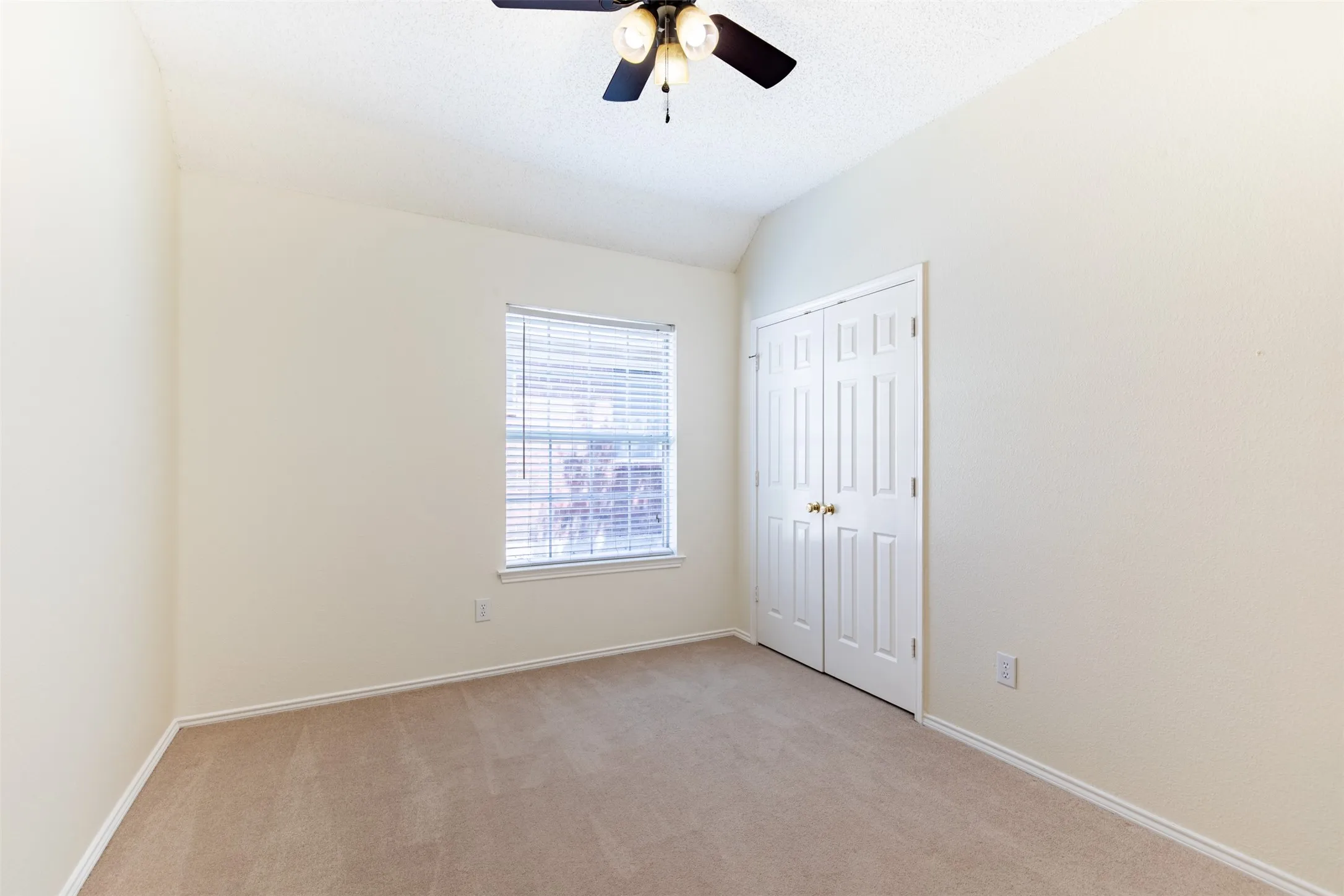 Secondary bedroom with double-door closet.