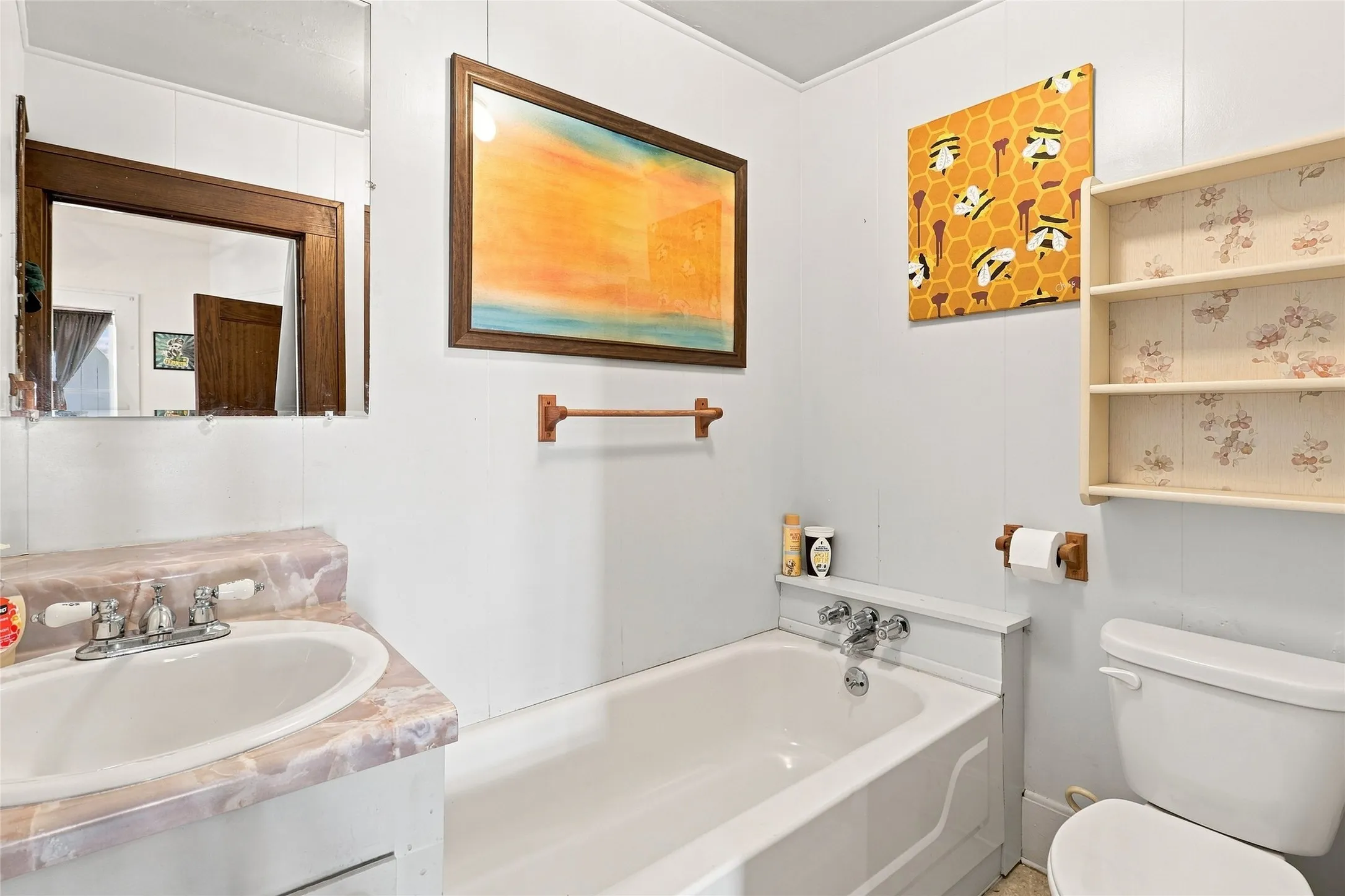 countertop, a wall-mounted mirror, and a toilet