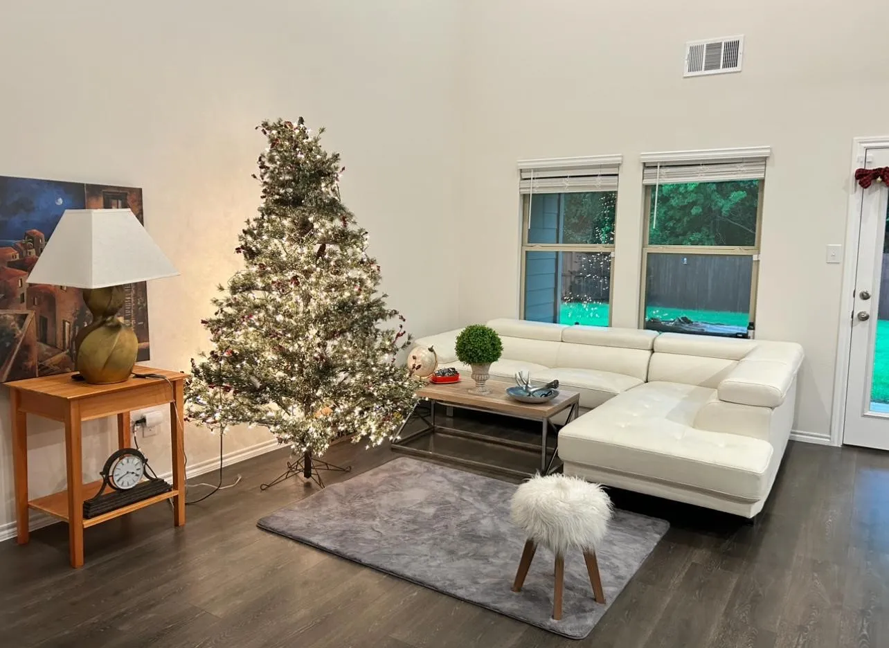Vaulted ceiling, wood-finish flooring, multiple windows, French door, and an air vent
