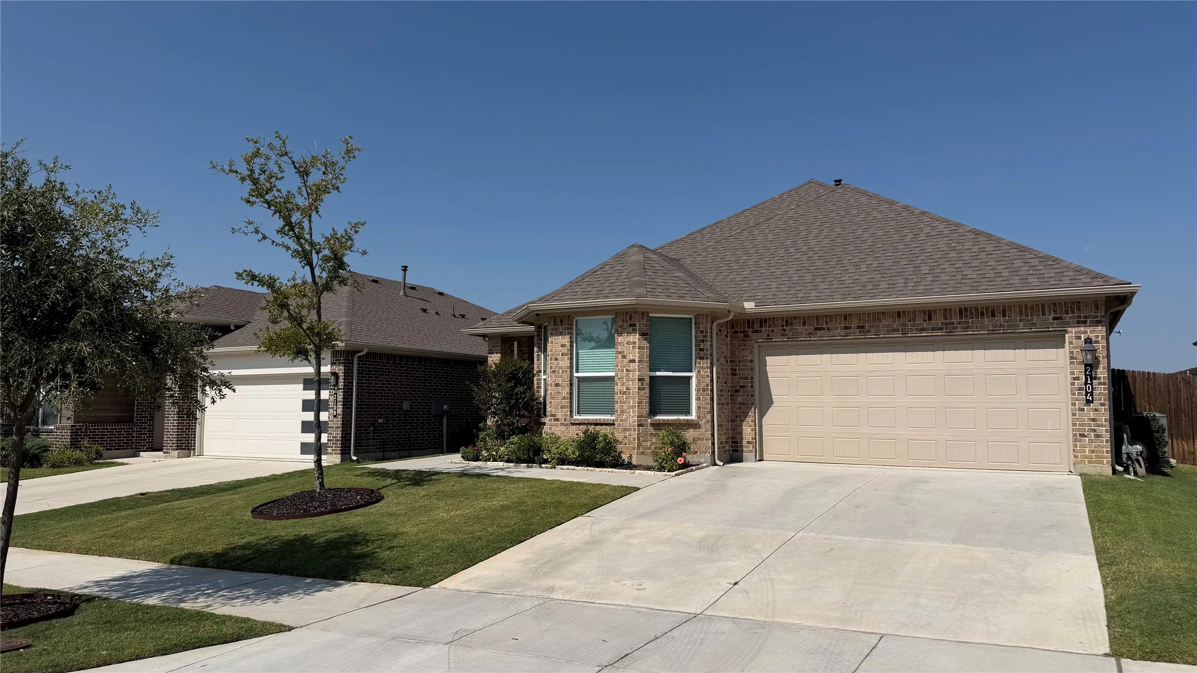 Brick exterior with a gabled roof and attached garage