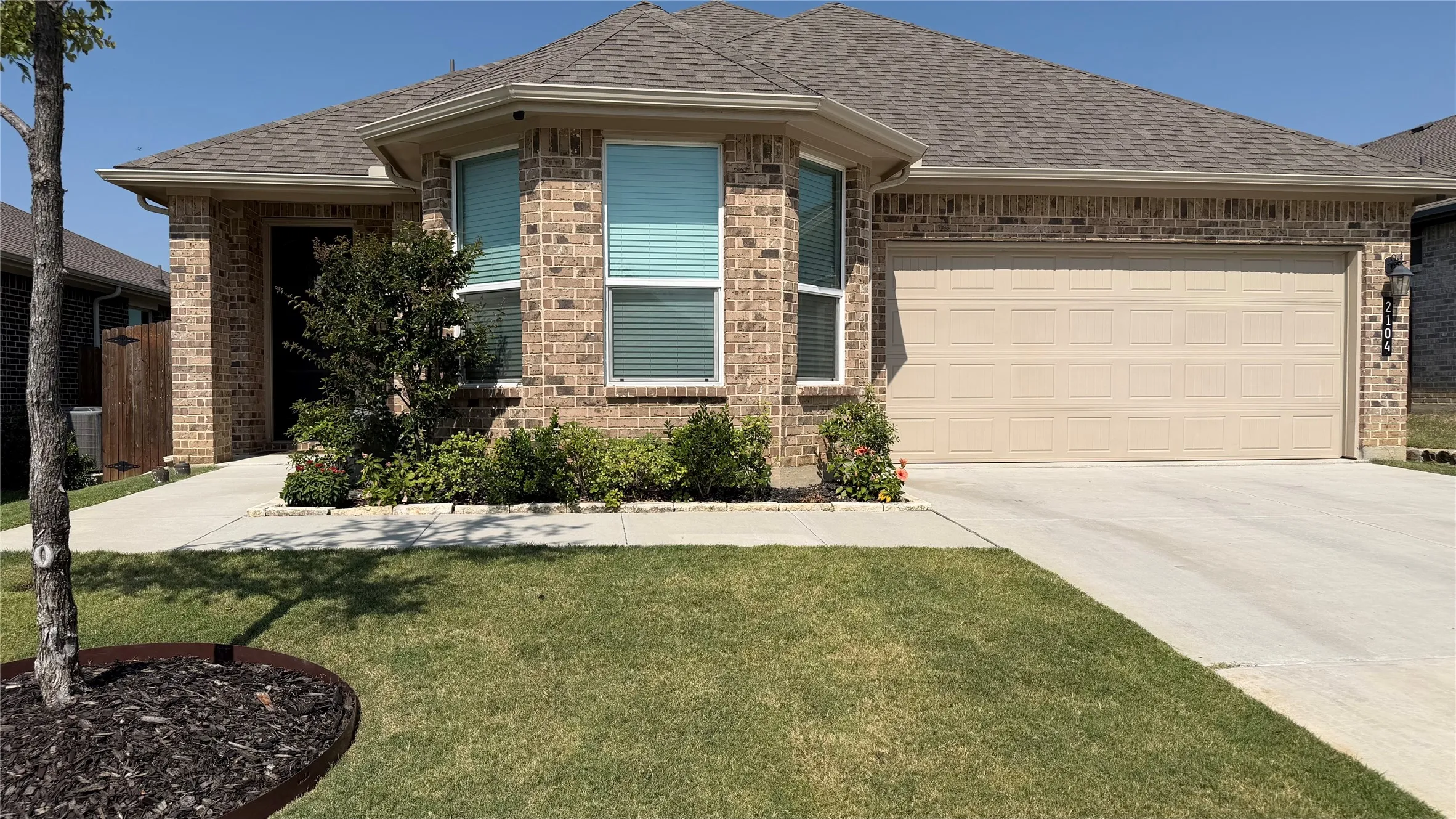 Brick exterior with a gabled roof and attached garage