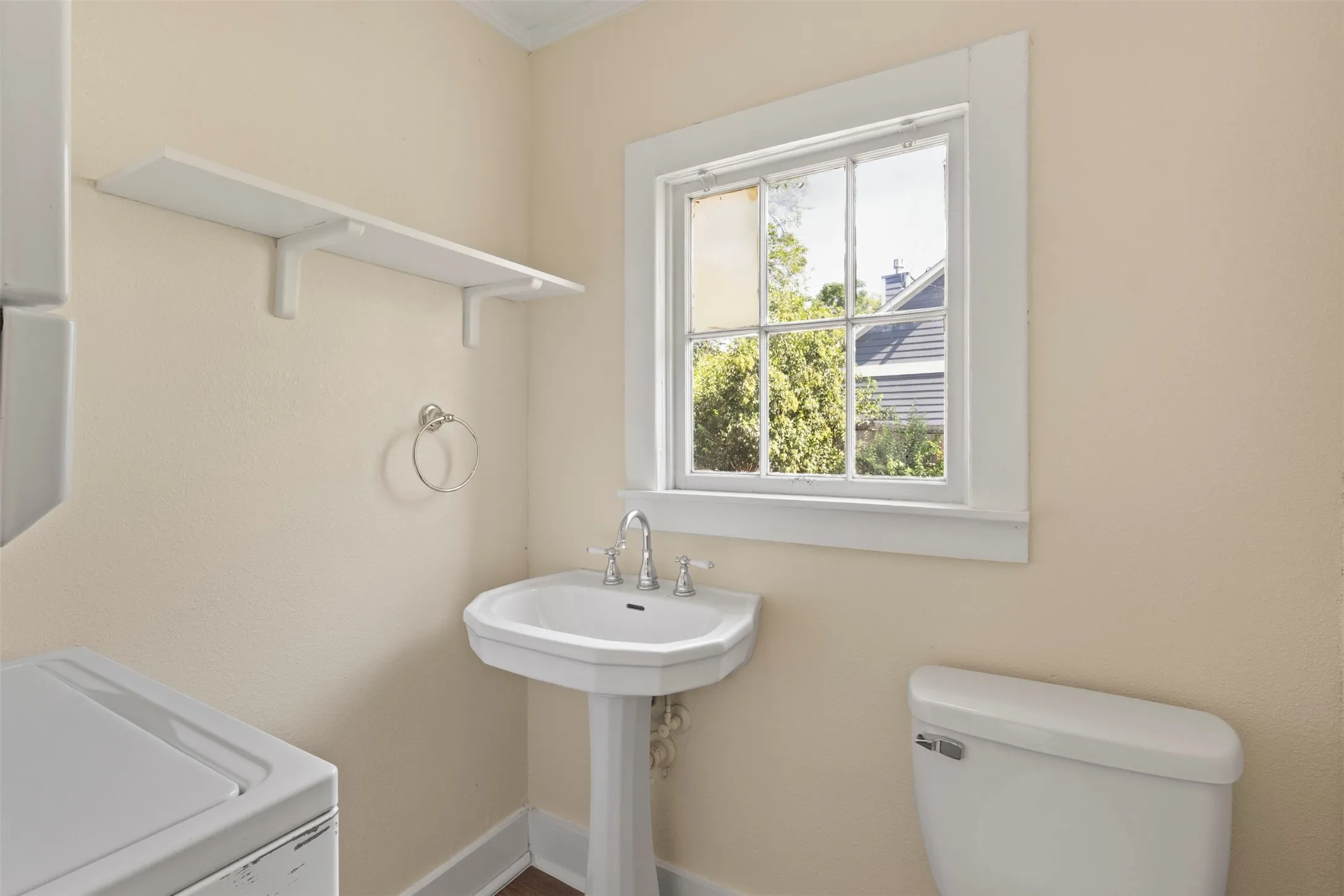 Utility room with stackable washer/dryer and half bath