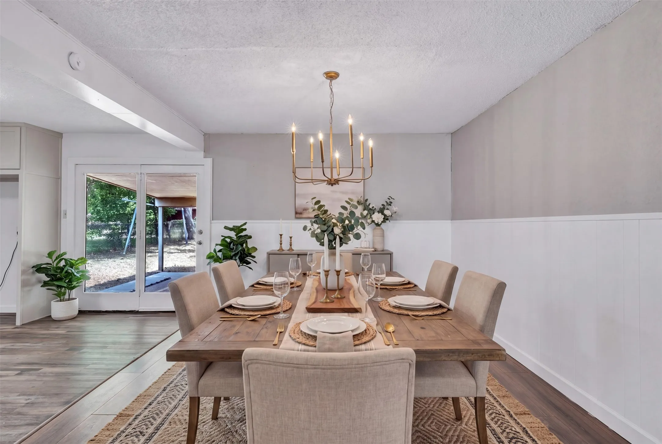 Shows double glass doors to backyard. Open to the Kitchen which is to your left. Virtually staged.