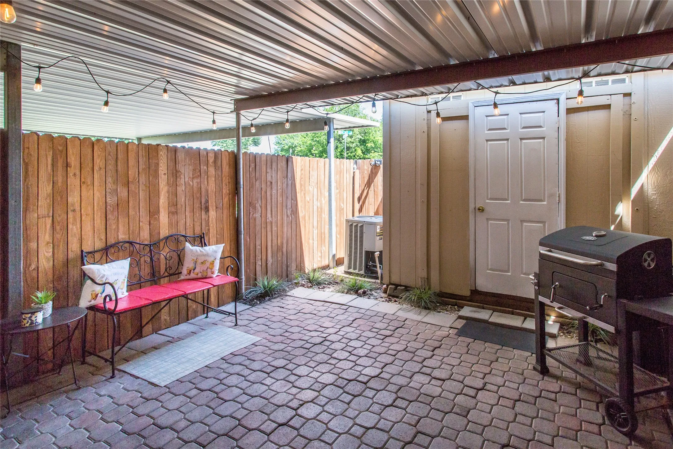 Covered outdoor patio featuring brick paver flooring