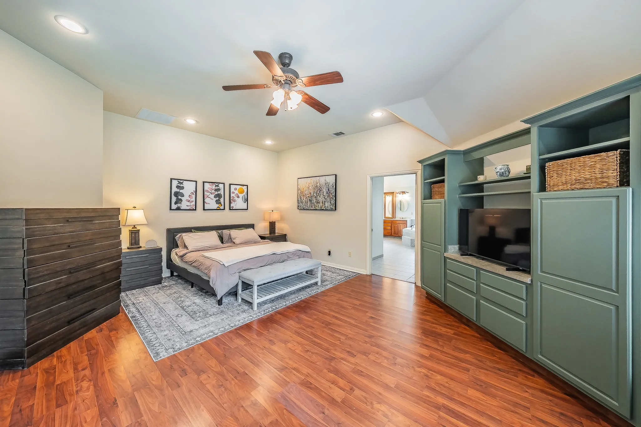 Wood-finish flooring with vaulted ceilings and recessed lighting