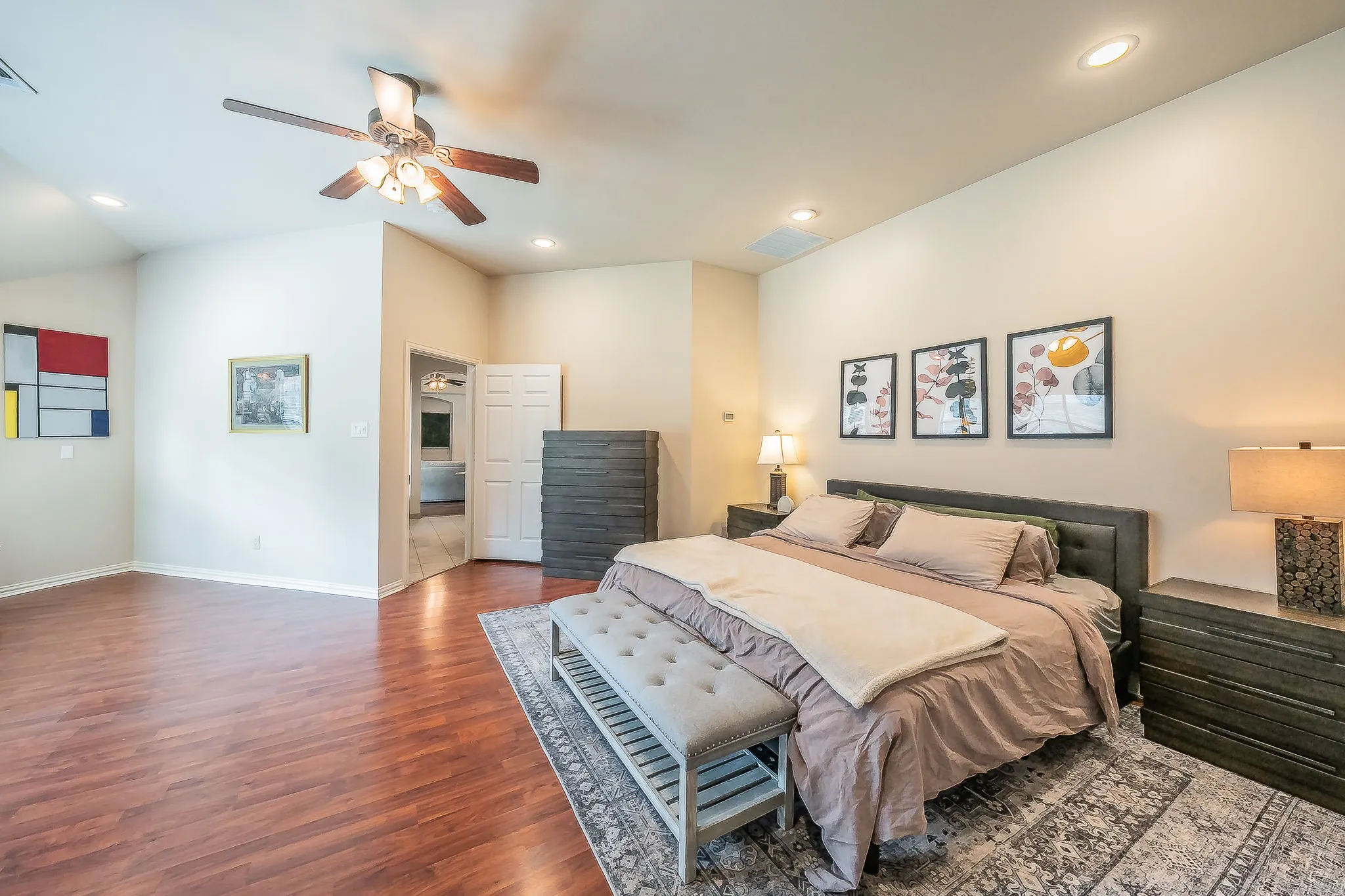 High ceilings with recessed lighting, wood-finish flooring, ceiling fan, and two-panel doors