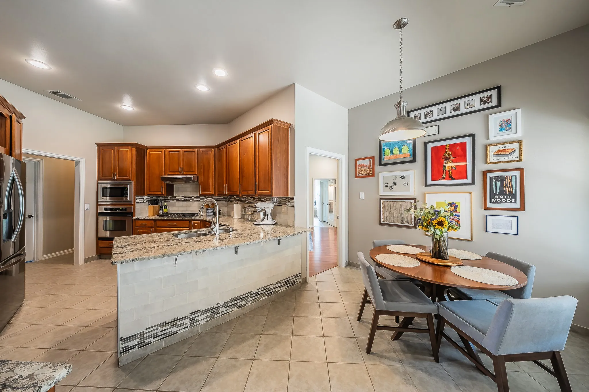 Open-concept kitchen with wood cabinetry and stainless steel appliances