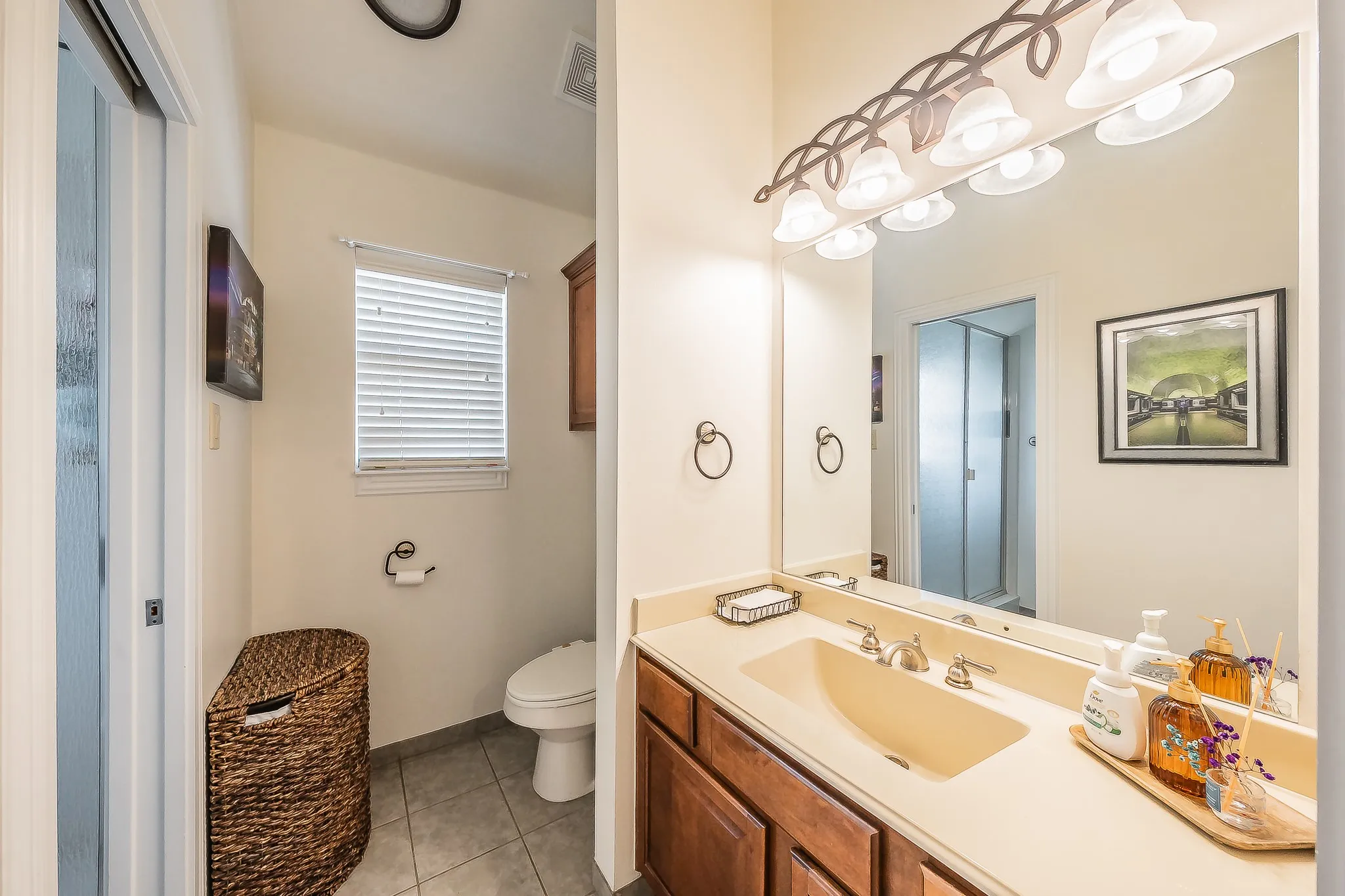 Vanity with an integrated sink, polished chrome faucet, and wood-finish cabinetry