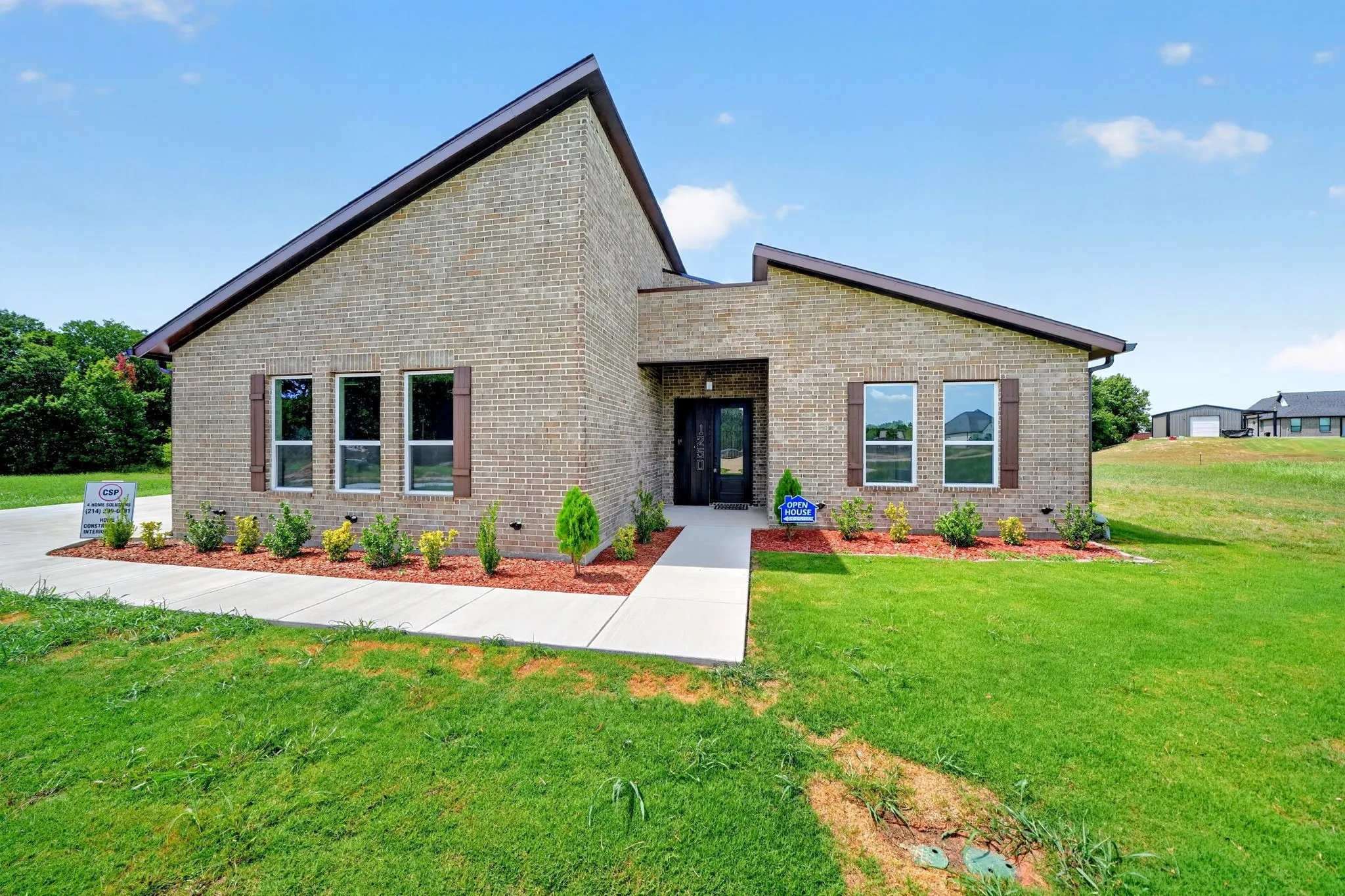 Brick exterior with contrasting trim, multiple window units, and a structured entryway