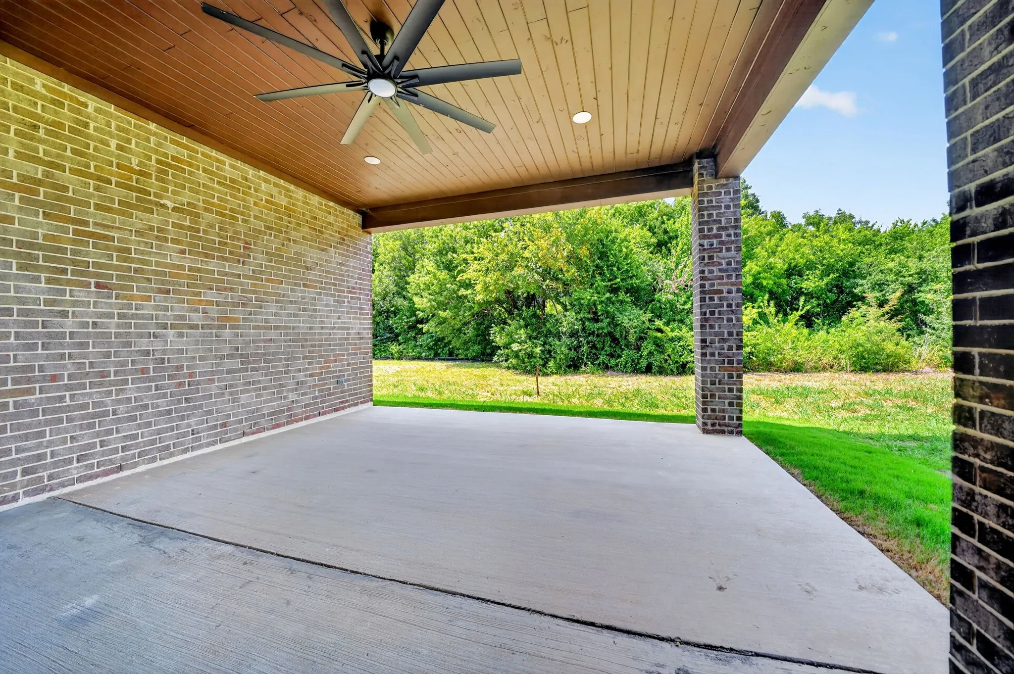 Covered patio featuring a wood-finish ceiling with recessed lighting and a ceiling fan