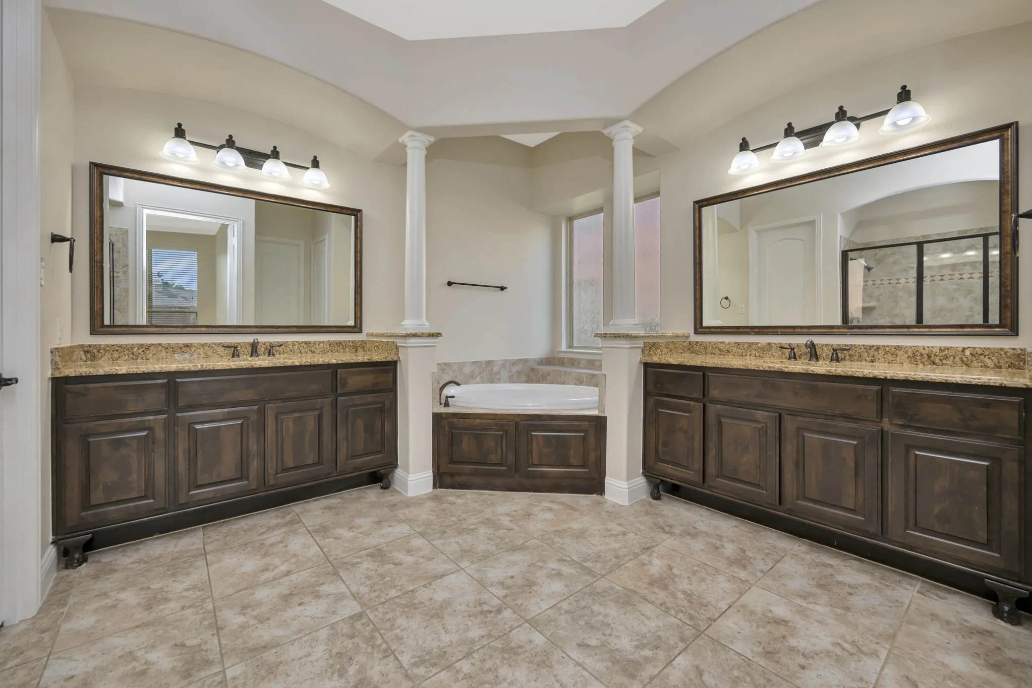 Spacious and Spa-Like with separate granite topped vanities and soaker tub!