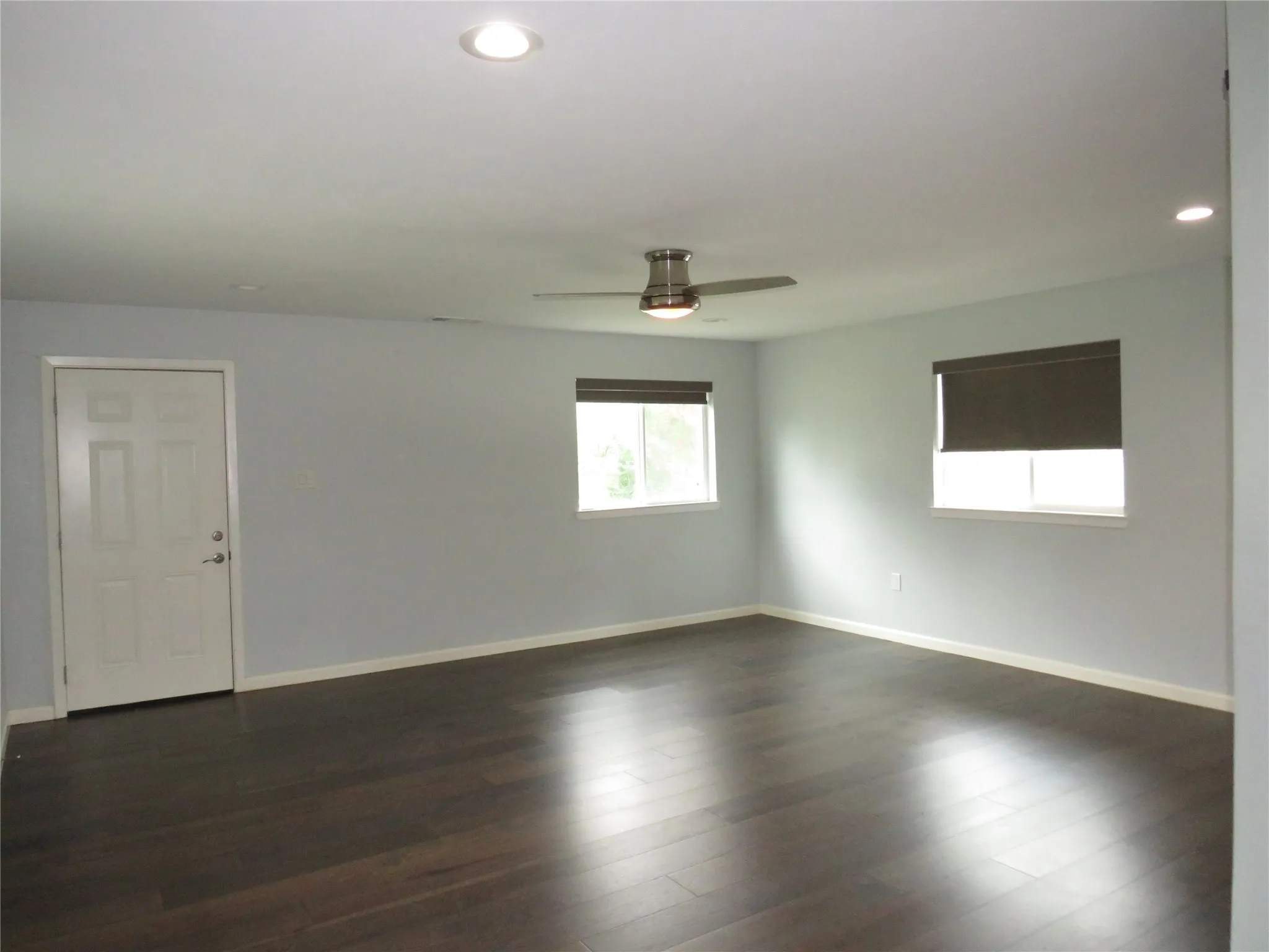 Recessed lighting, dark wood-finish flooring.