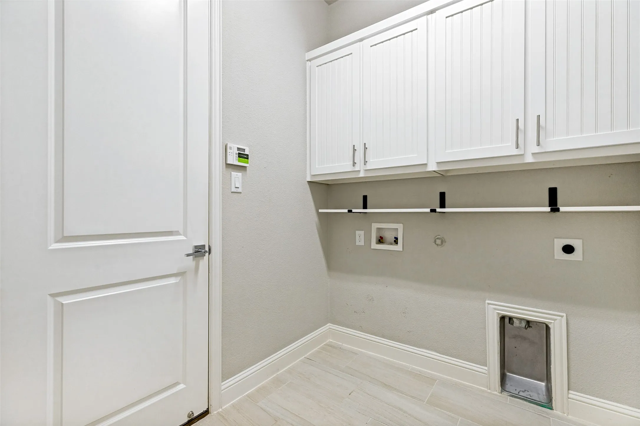 White shaker-style upper cabinetry with linear hardware