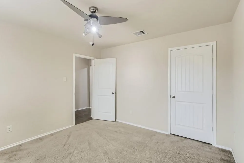Carpeted flooring, contemporary ceiling fan with integrated lighting, white interior doors, and neutral wall paint