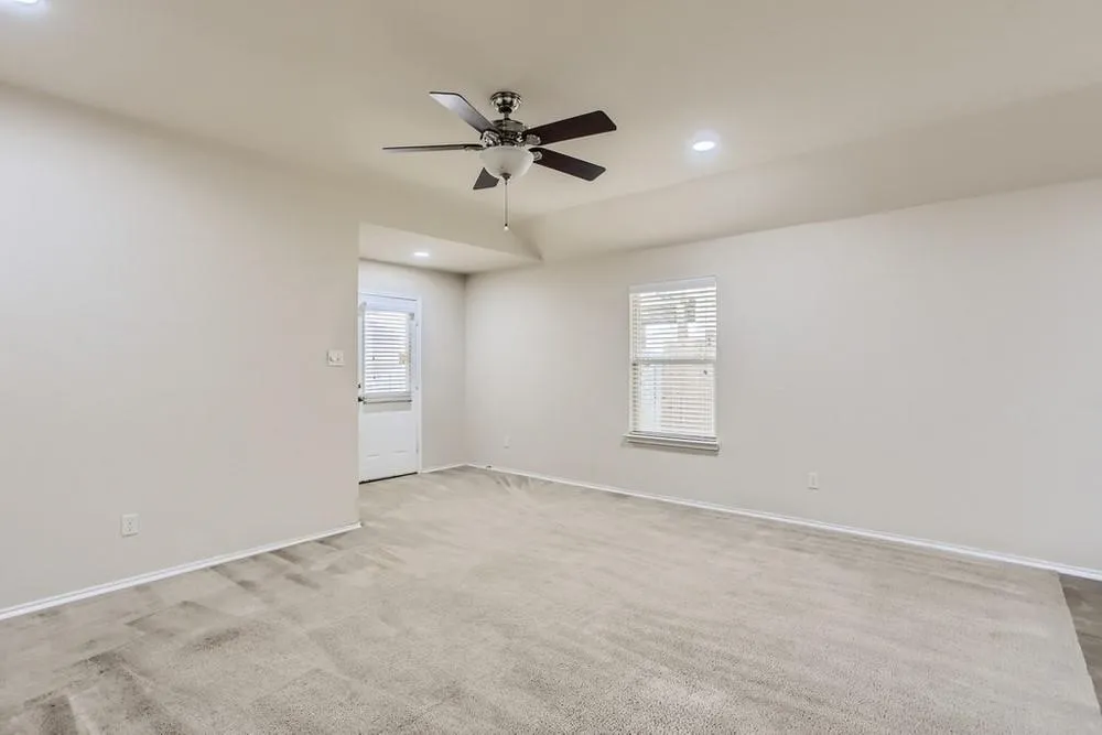 Recessed ceiling lighting, ceiling fan, neutral wall paint, carpet flooring, and window with blinds