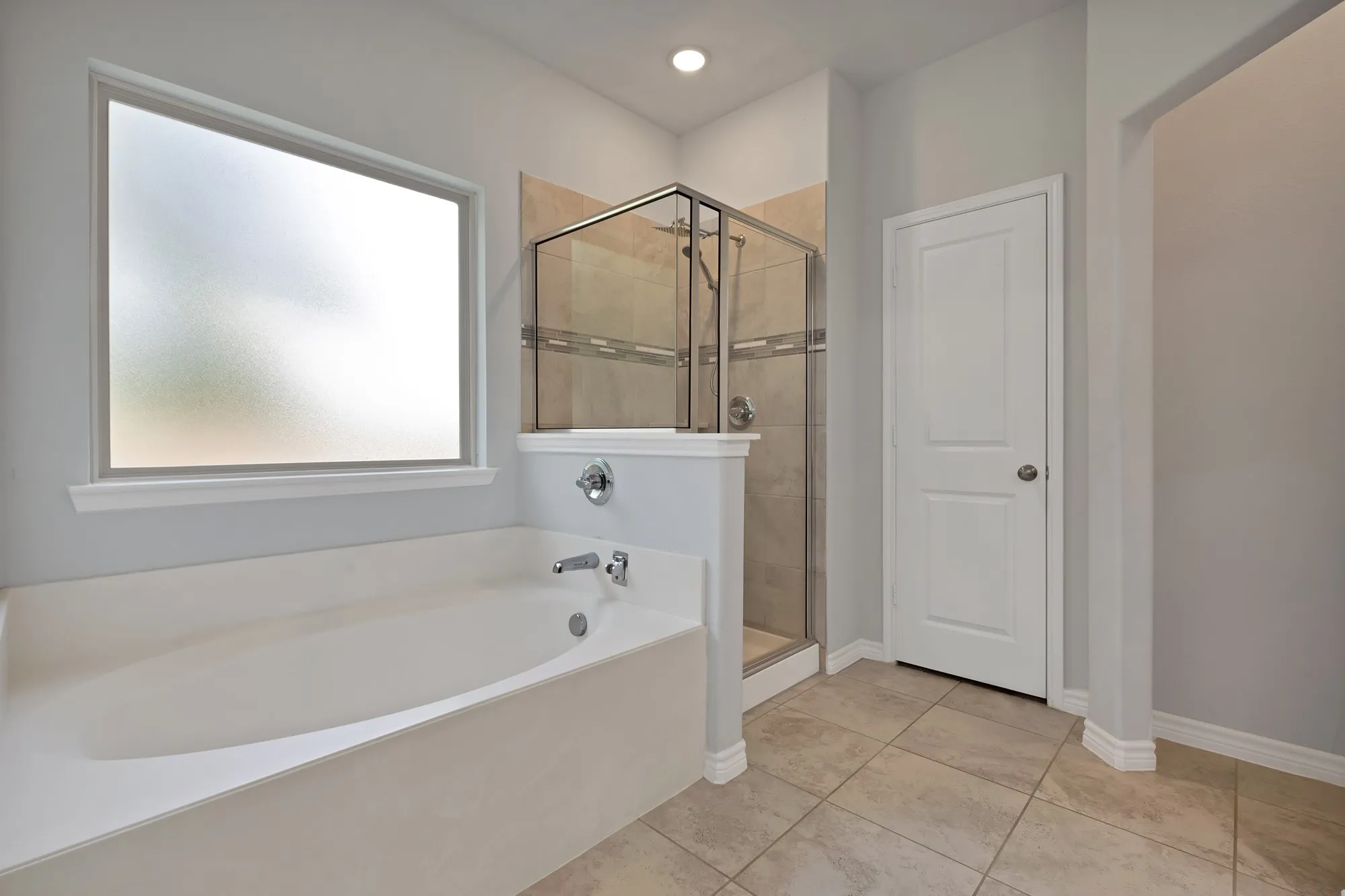 Bathroom featuring a garden tub, a stall shower, and tile patterned floors