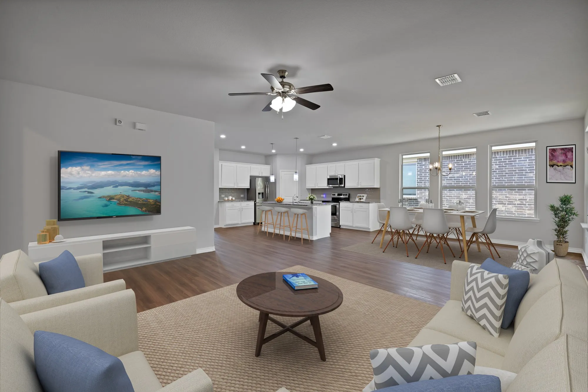 Living area with dark wood-type flooring, a ceiling fan, a chandelier, and recessed lighting
