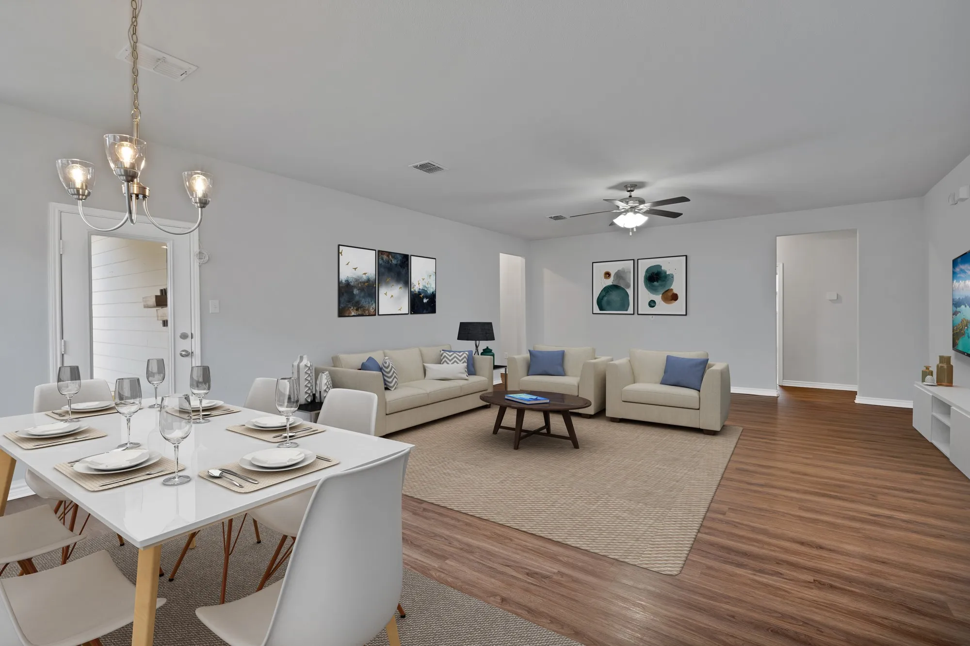 Dining area with wood finished floors, ceiling fan, and a chandelier