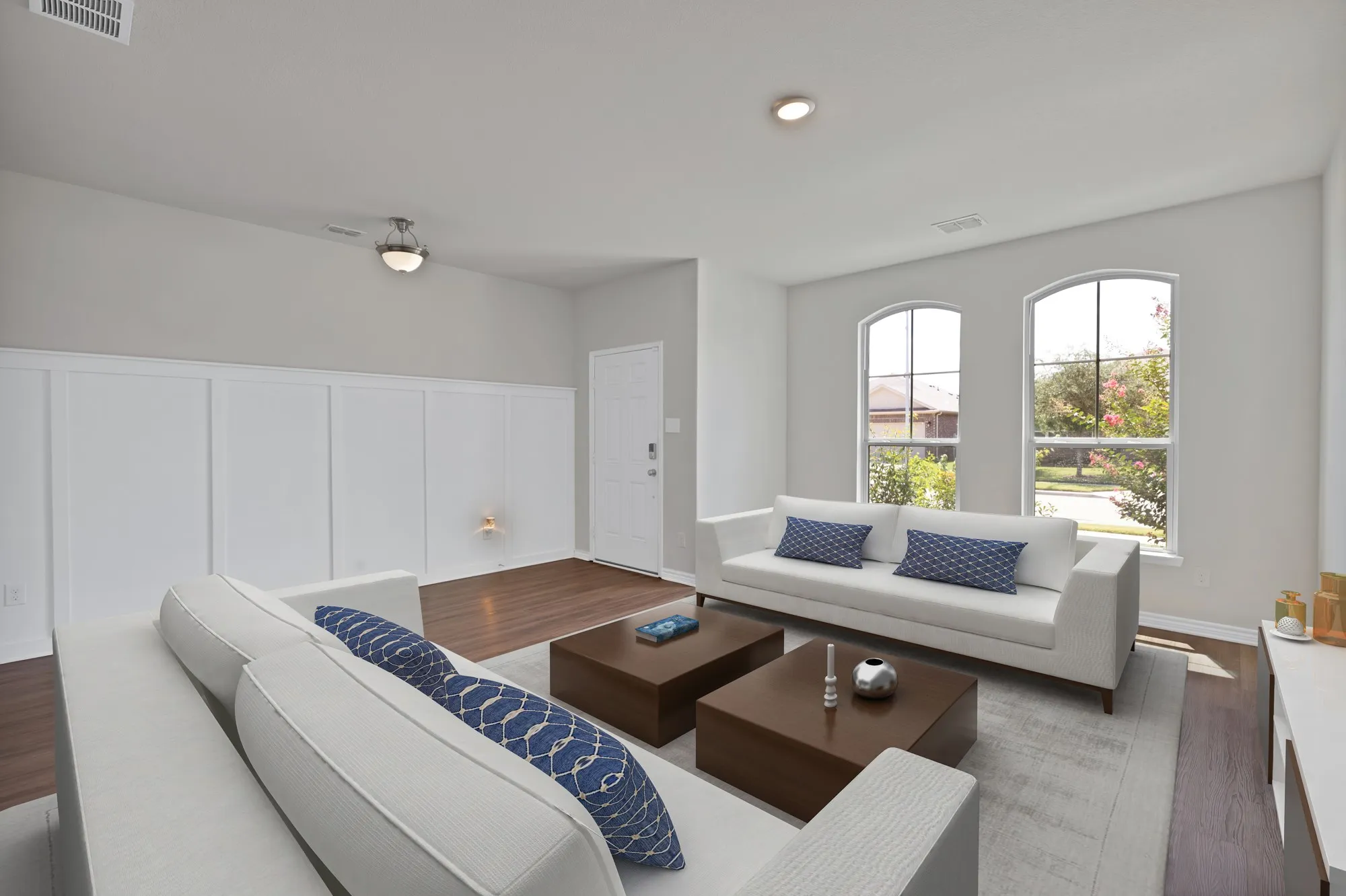Living area featuring wood finished floors and a decorative wall