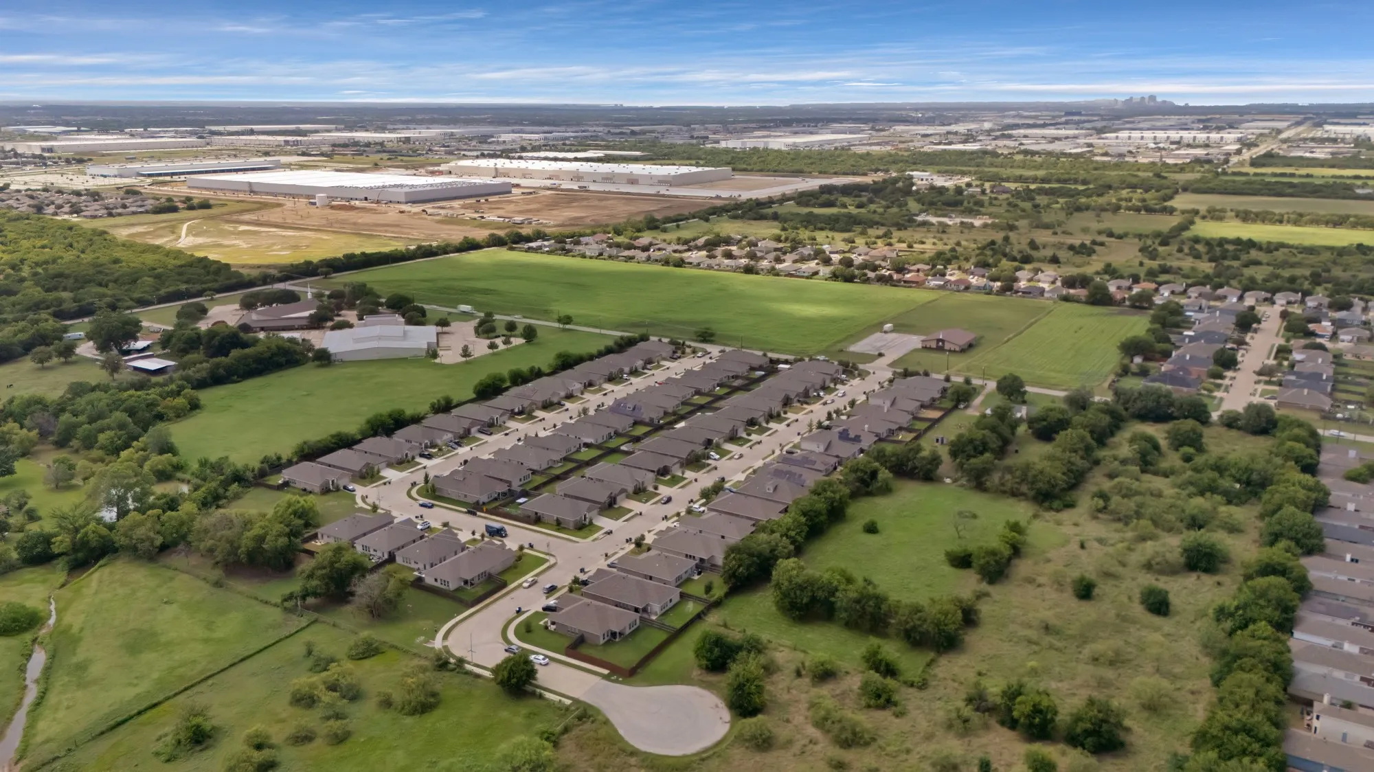 Aerial view of property's location featuring nearby suburban area