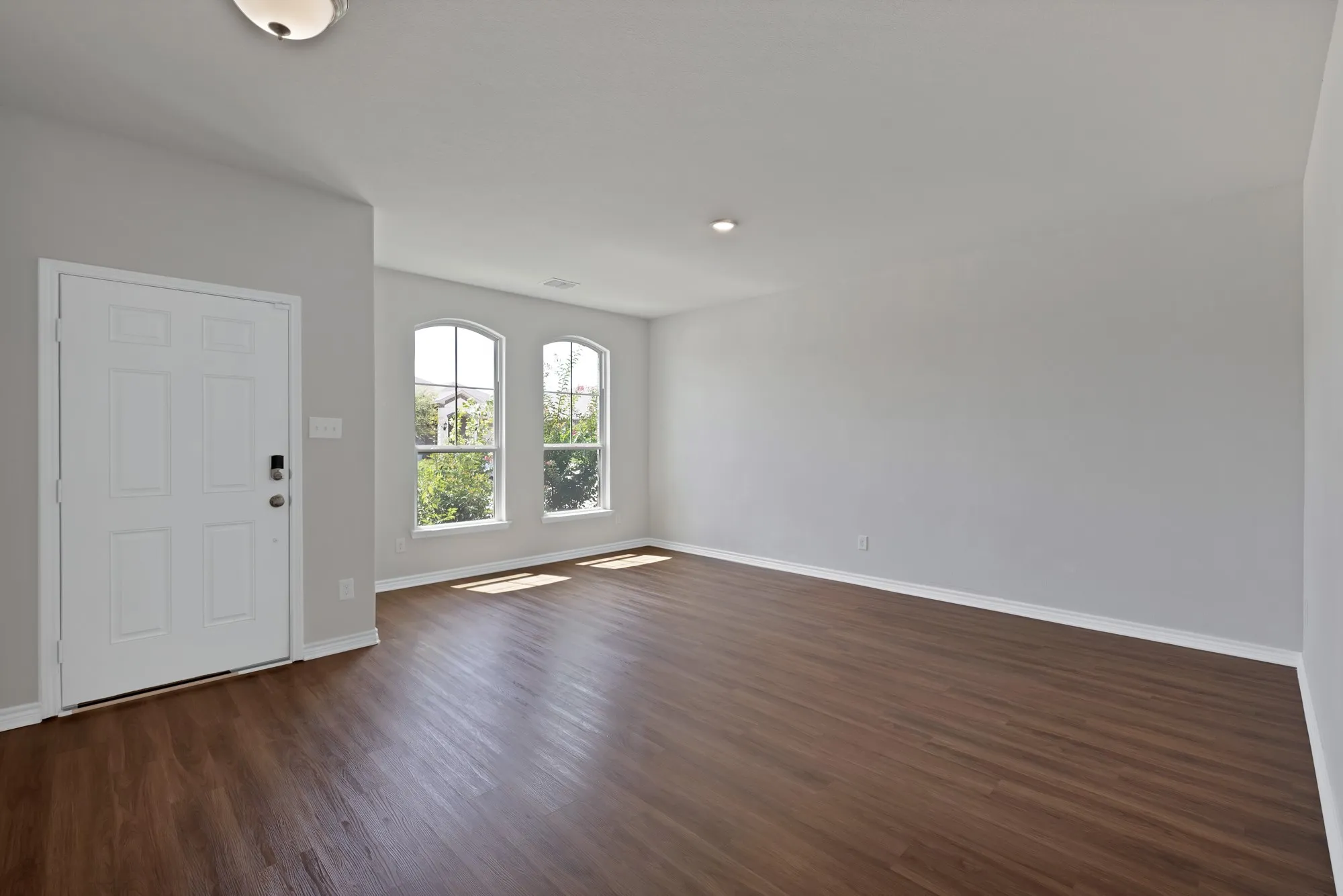 Entryway with baseboards and dark wood-type flooring