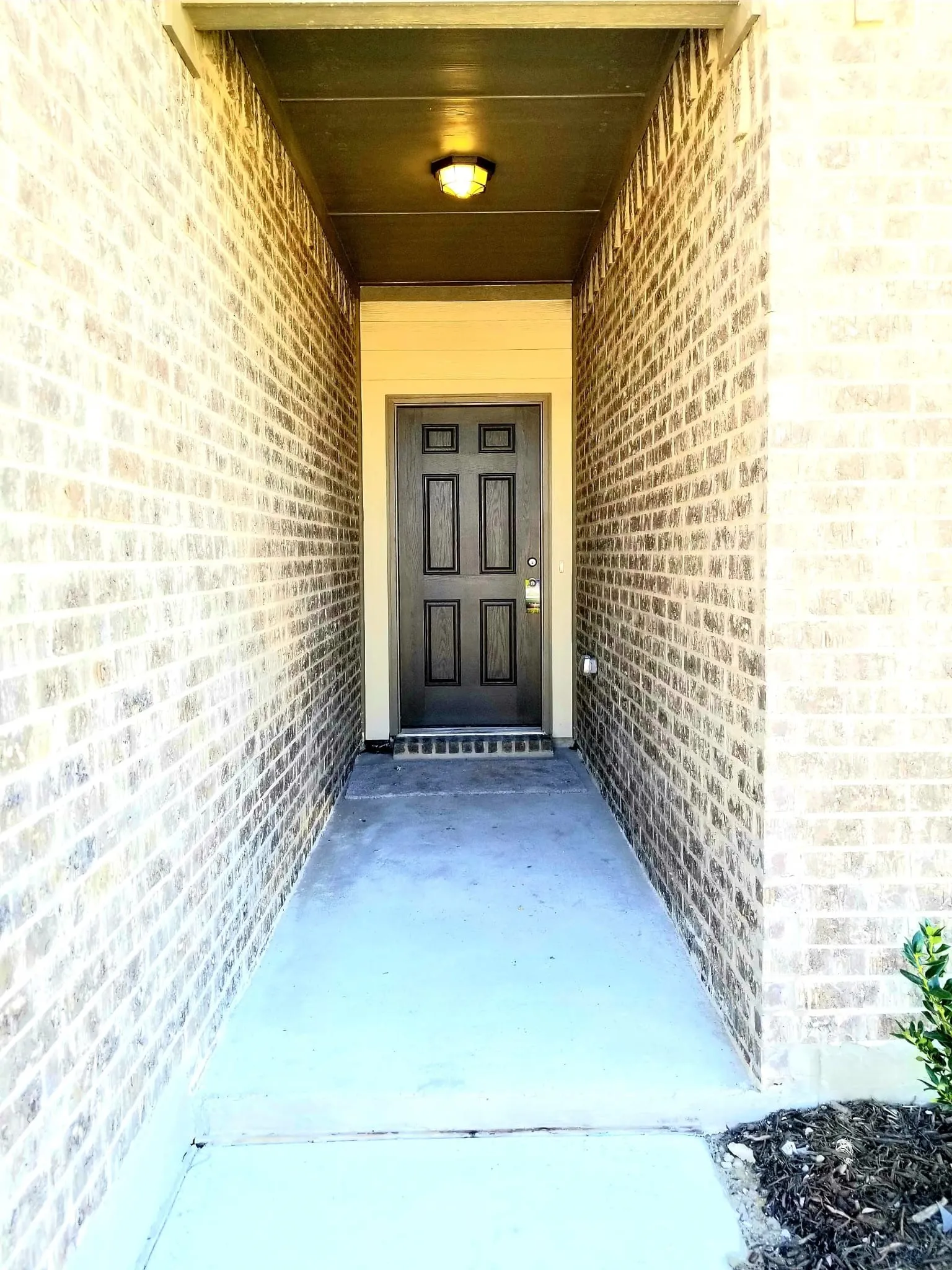 Brick exterior with a covered entry