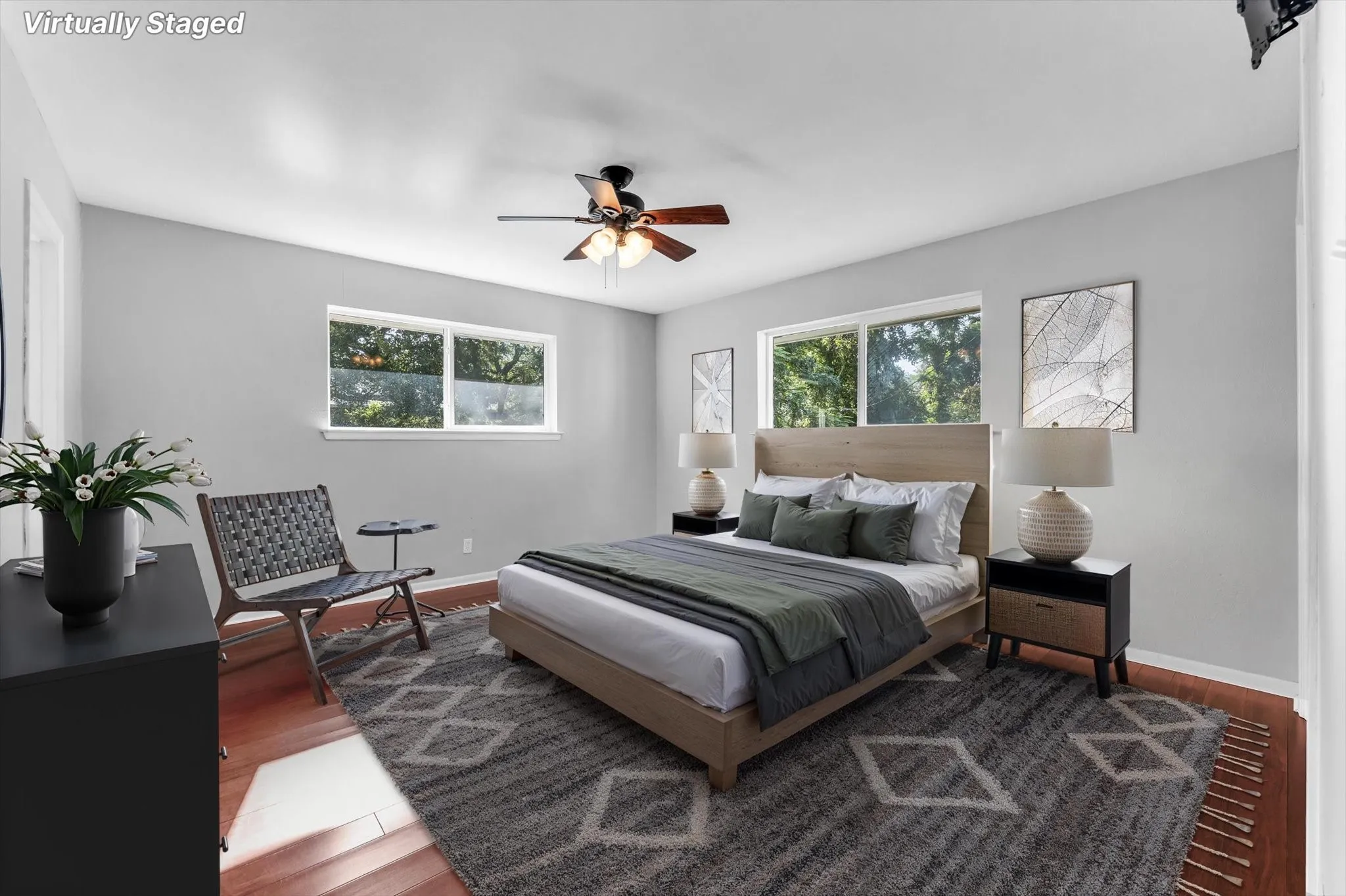 Wood-finish flooring with a ceiling fan and dual windows