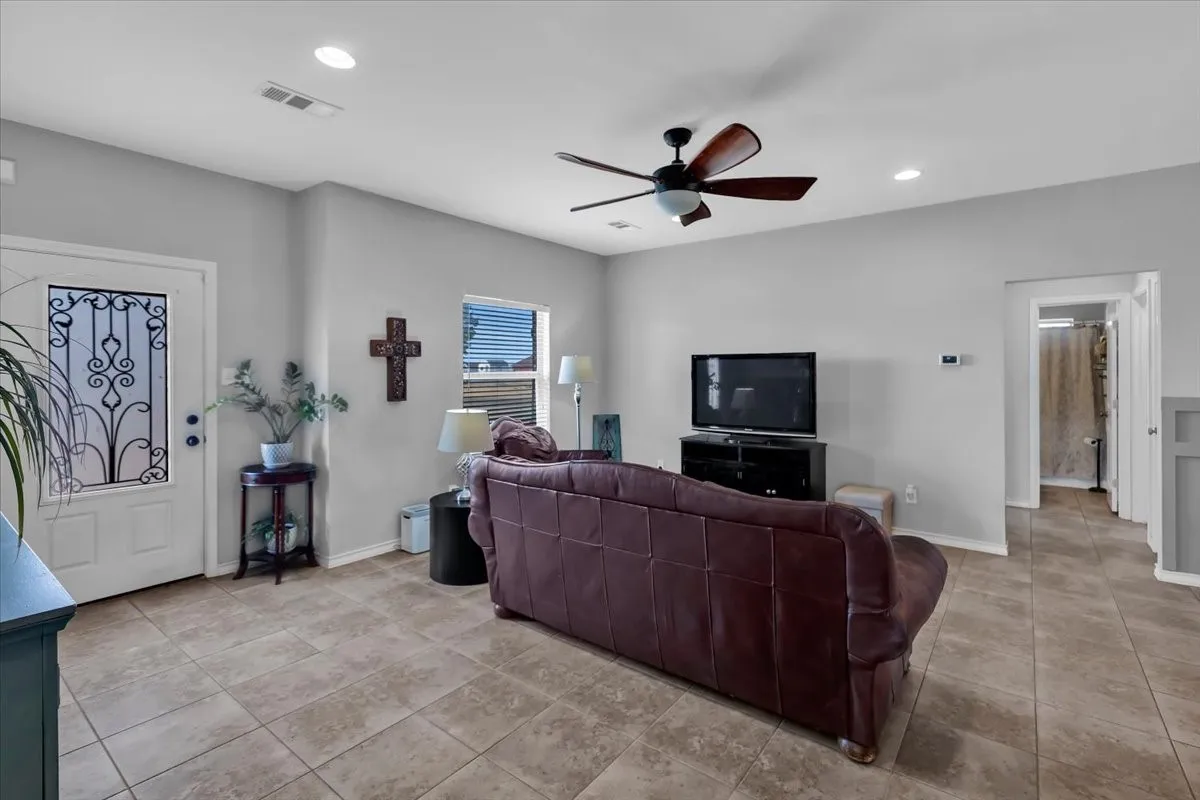 Tiled flooring, recessed lighting, and a ceiling fan with integrated lighting